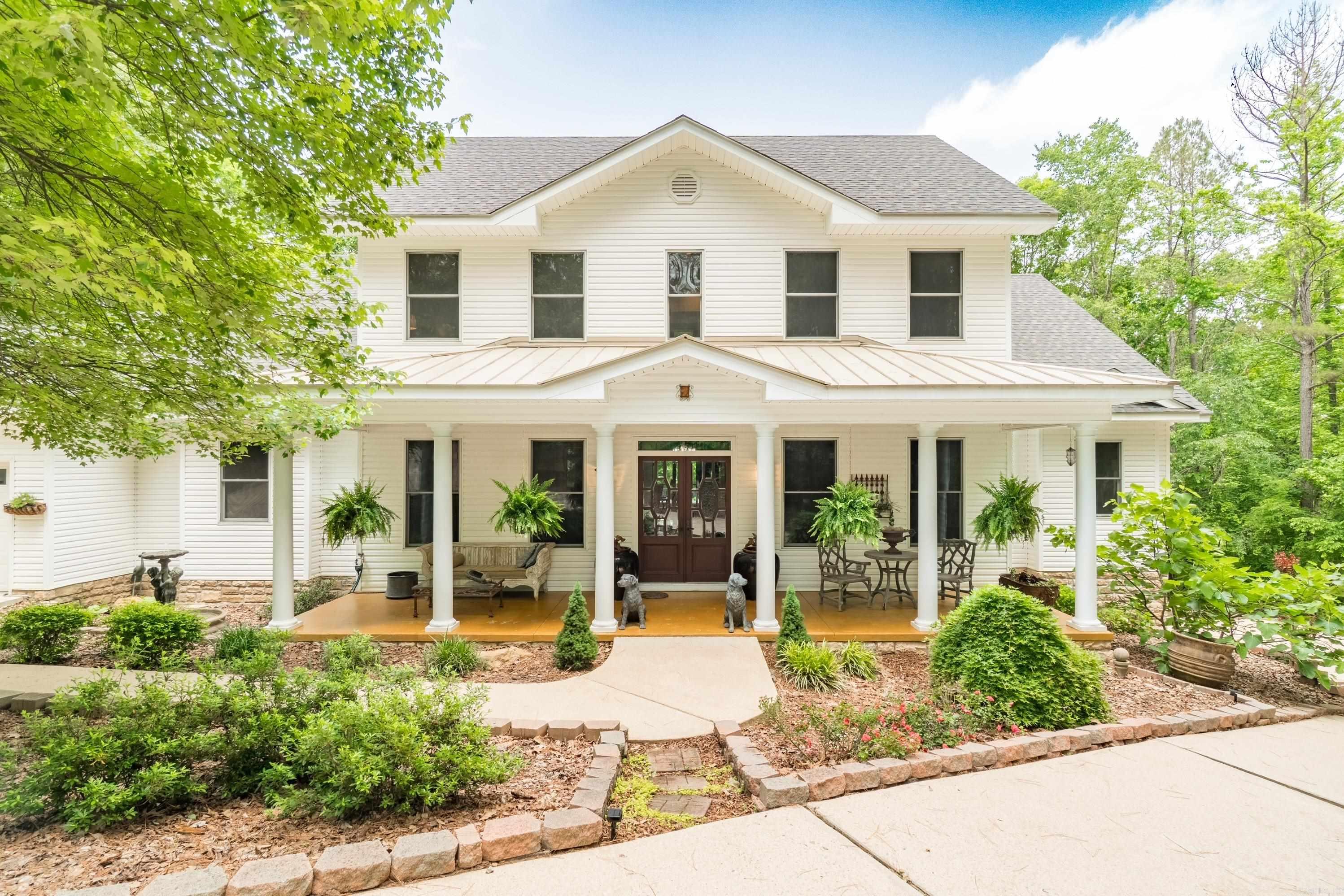 Southern Elegance Meets Modern Comfort- Step onto the sweeping front porch—perfect for relaxing or catching up with friends. Enter the foyer through antique double leaded-glass doors and feel instantly at home. This home features generously sized rooms including a formal dining room comfortably fits a 12-person table. A cozy living room invites quiet conversation or serves as an office. The family room opens to mountain and forest views, flows into a chef’s dream kitchen—professional-grade stove, double ovens, warming drawer, pot filler, open shelving, copper farmhouse sink, oversized pantry, and butler’s pantry. Enjoy indoor-outdoor living: the breakfast room connects to a screened porch, while the deck with hot tub flows from the family room. The primary suite includes a spa bath - double vanities, soaking tub, walk-in shower, and dual walk-in closets. A half bath and laundry room complete the main floor. Upstairs offers two baths and four versatile bedrooms—each with walk-in closets—currently used as guest room, office, exercise, and craft room. Downstairs includes two garage bays, workshop/golf cart parking. All set on a beautifully landscaped 3/4 acre lot. Central vac.