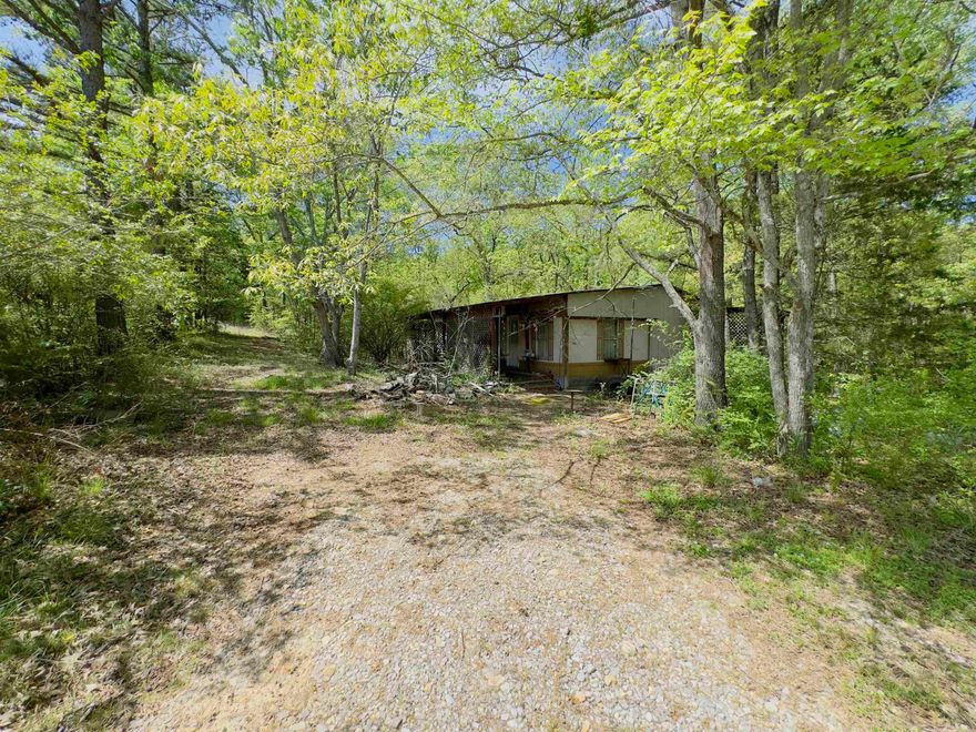 Nestled in the Ozark Mountains, along Hwy 9 S, Melbourne, Arkansas, this 2 acre property is in a prime location.   Residents of this area are treated to the best of both worlds – serene rural living and easy access to essential amenities, including shopping centers, dining establishments, healthcare facilities, and educational institutions. Everything you need is within reach.  There are many outdoor activities available in the area, such as fishing, hunting, hiking, scenic outlook locations, and much more!   While the property features a 840 square foot mobile home, it's worth noting that the structure needs a significant renovating and may not be suitable for immediate occupancy. Currently, the interior details of the mobile home are unknown.   However, this presents a unique fixer-upper opportunity for prospective buyers to customize the space according to their style and preferences. Alternatively, for those seeking a clean slate, there is also the option to clear the existing structure and build your dream home, business, or recreational retreat, the possibilities are endless.   Interested in making this property your own? Give us a call today!