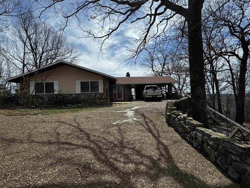 How about a spacious 3 bedroom 2 bath home overlooking Cherokee Village and surrounding territory?   Featuring over 2600 sf m/l of heated and cooled living space on two levels. The lower level also has a 20'x24' m/l shop-currently used for woodworking, and additional 500 sf m/l for storage -with heating and cooling-- mechanical room and possible storm shelter. On the main level are 2 bedrooms & laundry area. The living room has a site built stone fireplace with a Heatilator insert. From the living room, kitchen and dining areas one can view miles of scenic terrain-lakes, forest, and Cherokee Village. One can watch birds frolicking in the wind currents or maybe spy a bald eagle cruising by. The lower  living area has a wet bar, a fireplace with Heatilator, bedroom and bathroom. Access to the back yard is covered-perfect for enjoying the Ozarks gorgeous weather.   Additional features include a carport with an outdoor storage room. Need a place for an RV? A concrete slab with water, electric and waste water disposal is already installed.  If looking for a quiet but easily accessible home, lots of room and move-in ready this may be your new home.