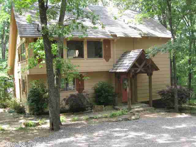 Wonderful lakefront home, 3 bedrooms, 2 baths, kitchen w/large eating bar big enough for 8 full size chairs. Open floor plan includes Living/Dining/Kitchen/Loft-Den. Slate floors throughout most of downstairs. Master down, 2 bedrooms up. Tall ceilings w/skylights, giant native stone vented fireplace. New paint inside and out in 2000. Central HVAC, wood and stone exterior. Restriced Lake/Golf S/D, lots of storage, circle drive. Very wooded and Rustic, Great Price
