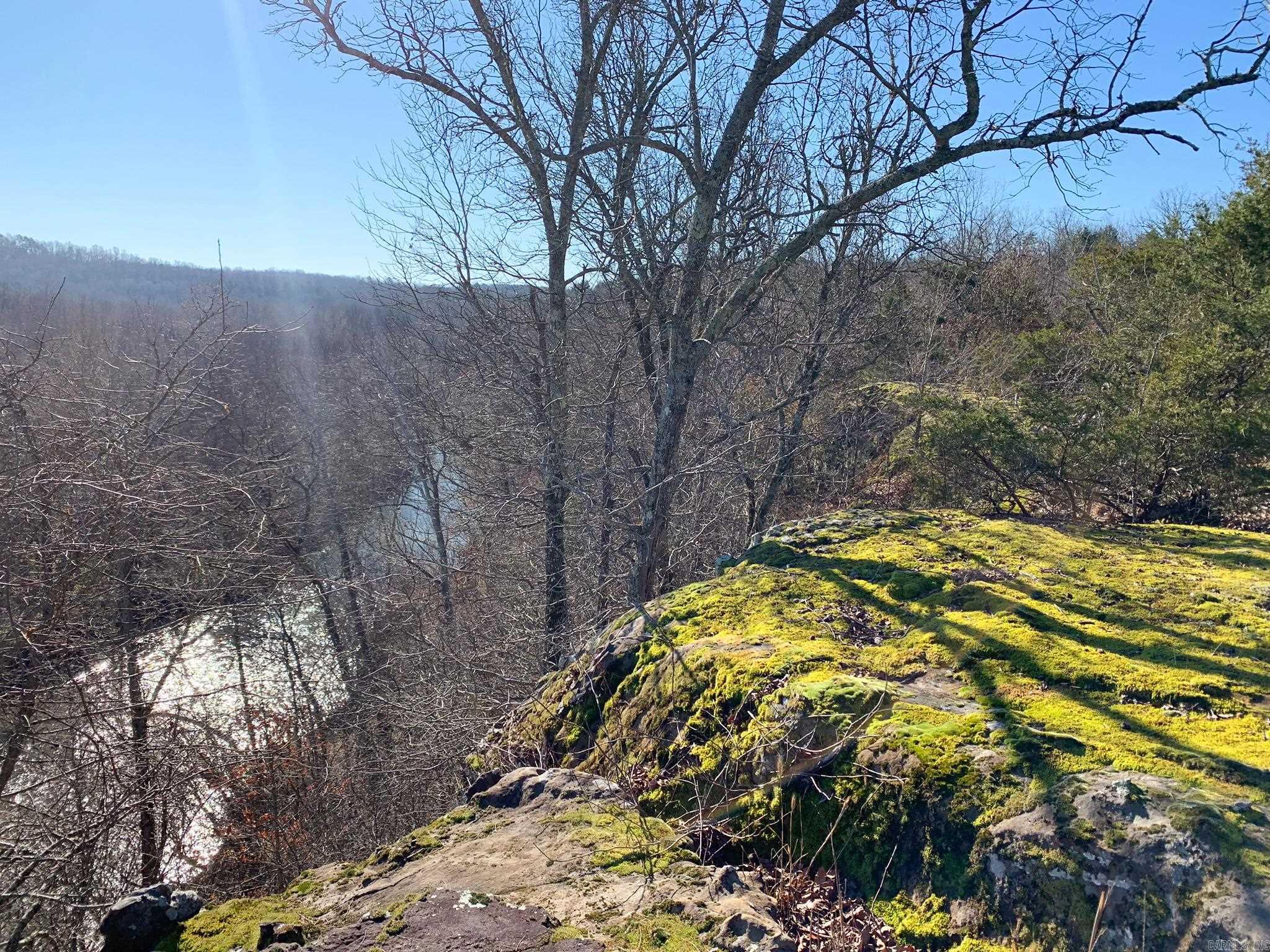 Build your getaway cabin overlooking a breath-taking view of the Cadron Creek valley, nestled amongst the gateway to the Ozarks. This 10-acre tract runs all the way back to the center of the gorgeous, year-round North Fork of the Cadron Creek. Rock bluffs jut out above the creek and make for amazing views across the creek valley. Rock shelfs and shelters dot the hillside. This tract has lots of wildlife and is peaceful and secluded -- almost entirely surrounded by other wooded tracts and with access from a quiet dead-end county road. This is the perfect place for a private residence, getaway cabin, off-grid build, hiking, fishing... you name it! Electric and water are available along Odom Point Rd. Only a 20-minute drive to Choctaw Marina on Greers Ferry Lake and one hour from Grinder's Ferry on the Buffalo National River. There are a total of 30 acres available at this location. Buyer can choose which 10 acres to purchase depending on what is still available or may choose to purchase more than 10 acres if available. No mobile homes allowed.