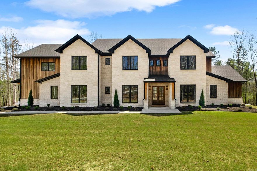 STUNNING PRIVATE ESTATE NESTLED ON ALMOST 4 ACRES IN CUL-DE-SAC! This exceptional home features a luxury kitchen with a Sub-Zero refrigerator, Thermador 8-burner range with double ovens, dual Thermador dishwashers, wine bar with fridge and ice maker, and an expansive Butler’s pantry. The kitchen opens to a breathtaking two-story living room with a floor-to-ceiling stone fireplace and expansive windows. The primary suite offers dual closets, private covered porch, and a spa-like bathroom with dual vanity, stunning shower, and free standing tub. Additional spaces include an office, formal dining room, bonus room with kitchenette, and a massive laundry room with cubbies and pet washing station. Enjoy outdoor living on the covered patio featuring cathedral ceiling, fireplace, and full outdoor kitchen. Extras include surround sound throughout, a fully irrigated lawn with raised play area, and a sceurity system with hardwired cameras. The steel 30x50 insulated shop with RV-size doors is perfect for the outdoor enthusiast! Only minutes from I-30, Benton, and Hot Springs!