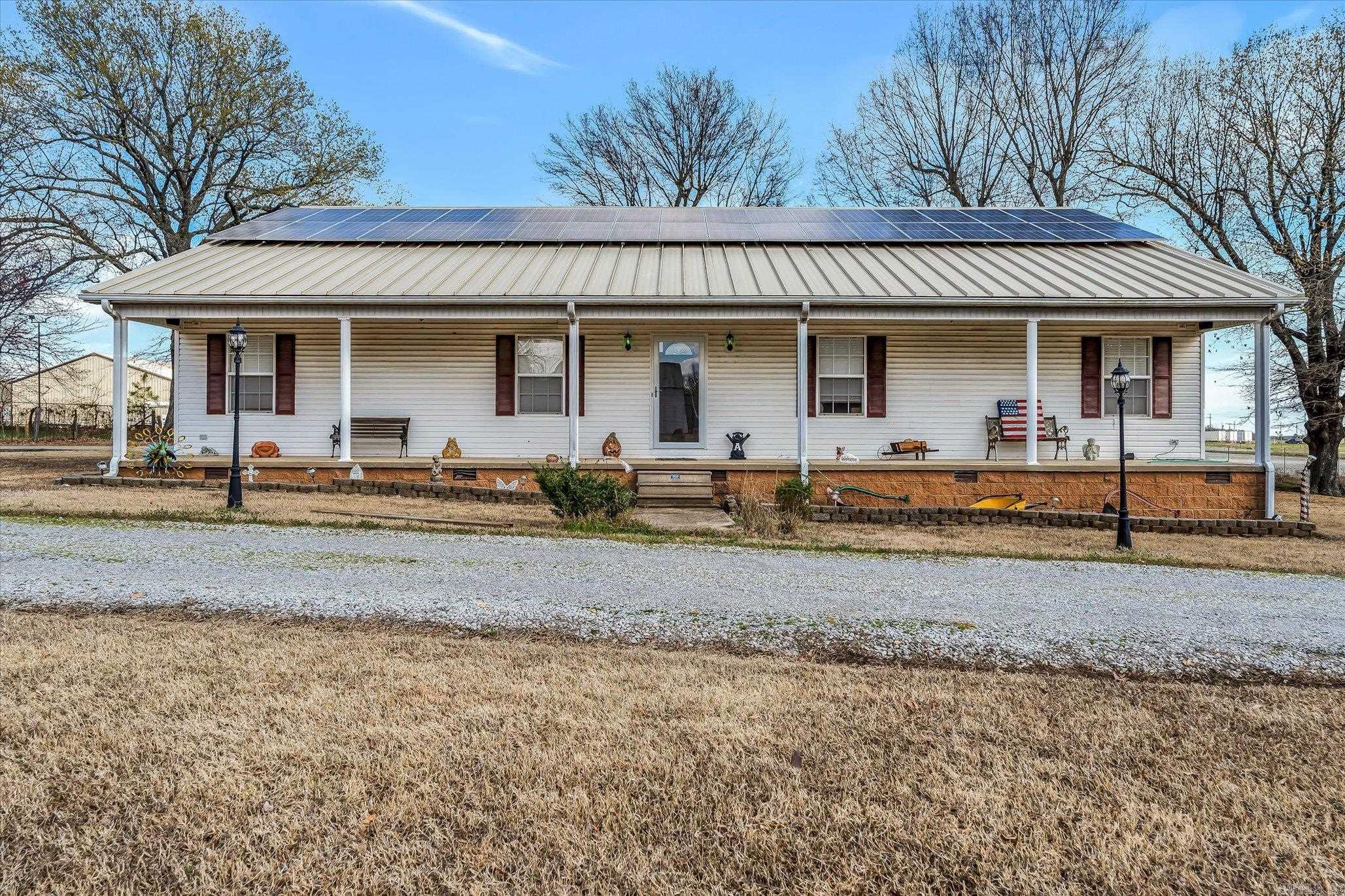 Spacious custom-built home in Paragould city limits sitting on 1.28 acres with plenty of amenities. This 3 bed 2 bath house comes with a bonus room equipped with built-in cherry shelves that could easily be used as a 4th bedroom. The kitchen is spacious with an island and all stainless-steel appliances convey with the property. Vaulted ceilings and a surround sound system in the living room are great for family movie nights. All 3 bedrooms have walk-in closets, the master is open and spacious with a double sink vanity, walk-in shower, and a tile surround jet tub. Who likes to save money on utilities? This home has 38 SOLAR PANELS installed on the metal roof that almost eliminates the electric bill! Itās a breeze to keep the original hardwood floors clean and tidy with a brand new central vacuum unit installed the first week of March. Sitting on the 1.28-acre lot is a huge 30X46 shop on a 6ā concrete slab with 3 garage doors (one side drive through and other side pull in), an office with half bath, insulated walls, and 12-foot ceilings. Next to the shop is a 2-car carport and an enclosed shed insulated with electric. There is an additional lot available to the north of the property