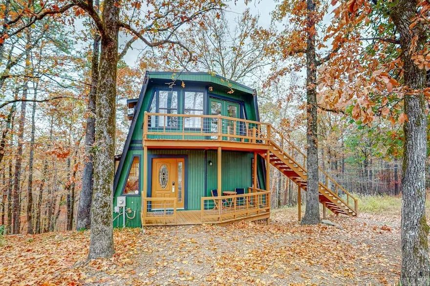 Turnkey Short Term Rental.  Enjoy amazing mountain views from this cozy modified A-frame cabin. With an open layout and lots of natural light, it feels like home.  Situated on an acre of private land, this peaceful retreat is just 15 minutes from Downtown Hot Springs. Whether you're out in nature or checking out downtown, this place is perfect for unwinding. The comfy living area has a sofa and TV for relaxing. The kitchen is fully equipped with all the appliances you need and has a breakfast bar for easy meals. Upstairs, there's another living room that leads out to a deck with fantastic views.