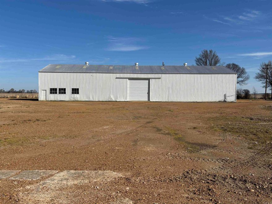 1 Farm Shop with parts storage bins and 3 story office/ inventory/ workshop bunkroom 70feet by 70 Feet 35 feet tall 2 overhead doors (25 feet tall) bathroom, cinder block walls, and metal framed building.  Full electric LED lighting,150-psig compressor, one welding plug, 110 volt plugs, overhead crane with junction box to place a 2 ton hoist if needed. Fully code compliant.  Electric outlets can be added to meet the lessee's needs. 1 Storage/manufacturing Shed 122 feet by 160 feet concrete flooring industrial strength load bearing floors throughout. One overhead door. No electrical power at this time. 1 Storage/manufacturing Shed 50 feet by 140 feet dual overhead doors with seperate storage or office space.  Full electric LED Lighting, one welding plug, and 110 volt plugs.  Fully code compliant. electrical outlets can be added to meet the lessee's needs. 1 Wooden storage barn/shed 50 feet by 54 feet with sheet metal roof and with two lean to sides that have concrete floors.  No electric power at this time. 1 brick veneer home/ office  2460 square feet 2 bath  with gravel driveway and carport Move in Ready.  Flat terrain with plenty of parking and additional building area if needed