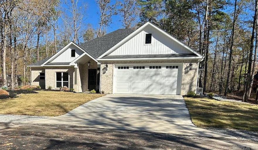 This custom-built home (only 15 months old)is located in the center of Hot Springs Village near the Woodlands Auditorium and Grove Park. It features an all-brick exterior, beautifully landscaped fenced yard with sprinkler system and flagstone patio. The home features an open floor plan with a large walk-in pantry, an island kitchen with a gas stove. Granite countertops, walk-in shower in the master bath. Hot Springs Village has a one-time buy-in fee of $2,000 paid at Closing. Saline County has not assessed the home, and the current Property Tax was for the undeveloped lot before construction of the home.     Saline County has not assessed the home and the current Real Estate tax is based on an undeveloped lot.