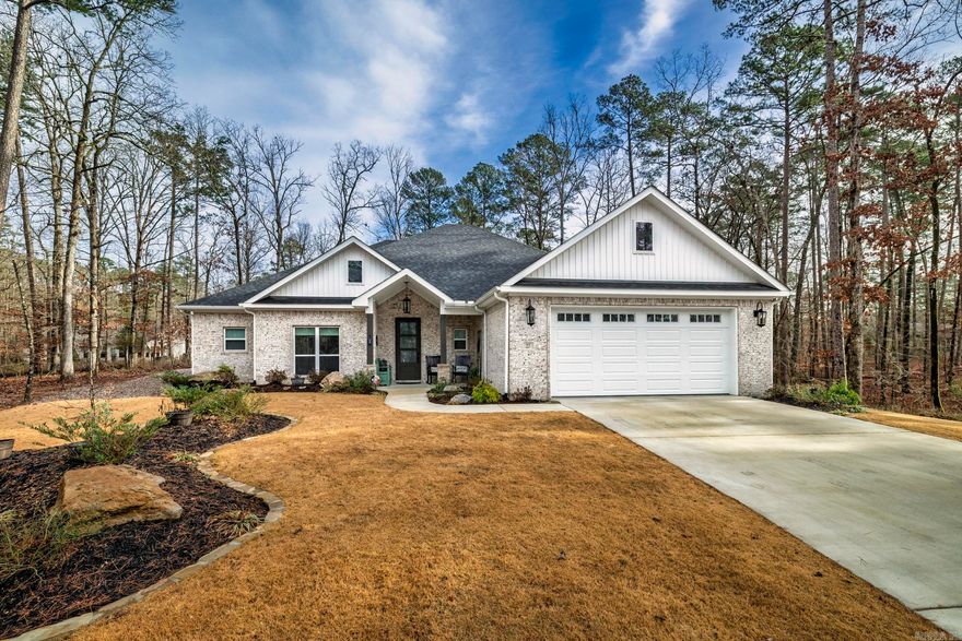 This custom-built home (only 15 months old)is located in the center of Hot Springs Village near the Woodlands Auditorium and Grove Park. It features an all-brick exterior, beautifully landscaped fenced yard with sprinkler system and flagstone patio. The home features an open floor plan with a large walk-in pantry, an island kitchen with a gas stove. Granite countertops, walk-in shower in the master bath. Hot Springs Village has a one-time buy-in fee of $2,000 paid at Closing. Saline County has not assessed the home, and the current Property Tax was for the undeveloped lot before construction of the home.     Saline County has not assessed the home and the current Real Estate tax is based on an undeveloped lot.