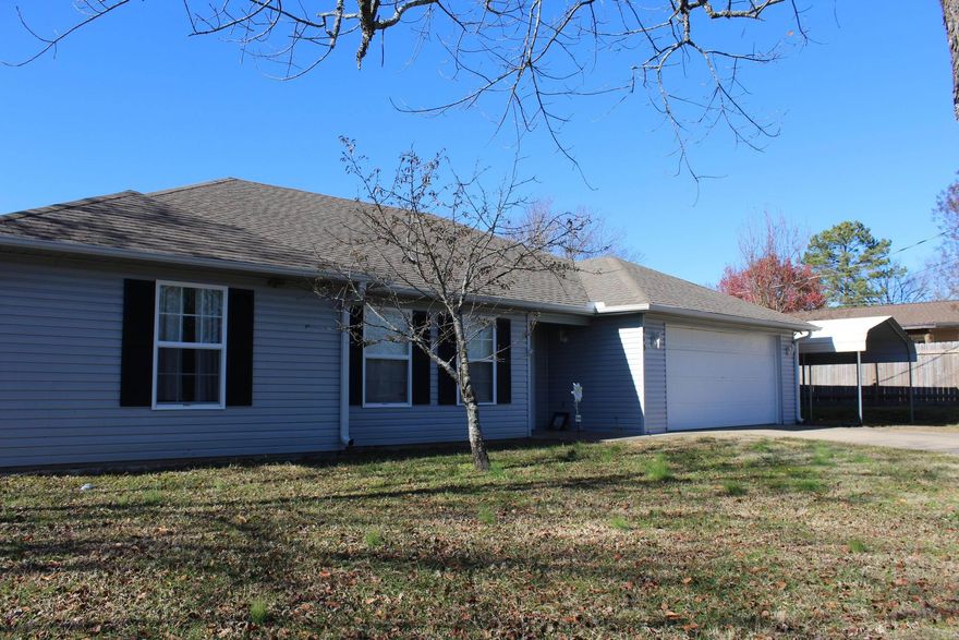 Nice home on large lot, close to schools, shopping, post office and more.  3 bedrooms, pantry, separate laundry room, 2 car garage, fenced yard.  Newer flooring, a/c unit is about 5 years old, gutters, carport.  Hot tub does not convey. Come see today, will qualify for VA, FHA, RD or conventional loans. One year home warranty with AHS offered to Buyer