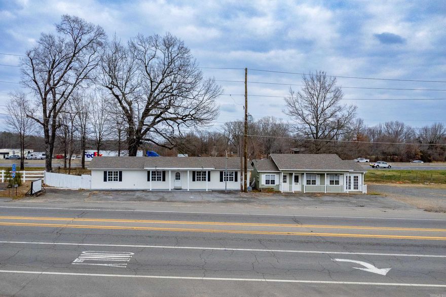 Rare opportunity to own two commercial office buildings fronting Highway 365 with Interstate 40 directly behind — offering both local visibility and major interstate exposure. Previously leased as a daycare and an insurance office, these properties are well-suited for a variety of small business uses, including professional services, boutique retail, contractor offices, salon/spa, medical, or for investors wanting income-producing office rentals. Highway 365 frontage. Each office offers excellent visibility and accessibility, a kitchenette, a full bathroom, and central heating and air. The white office building is 1200 sq feet and features laundry hookups, a refrigerator, and an additional private office, creating more flexibility. The green office building is 800 square feet.  Approx 76,000 vehicles per day pass through Mayflower via I-40, with 16% of that being truck traffic. An average of 9,400 vehicles pass through Mayflower via Highway 365**. Whether you’re looking to operate two separate businesses, occupy one & lease the other, or expand your investment portfolio, the possibilities here are wide open. Sold as-is.  Tax amount is for both properties combined.