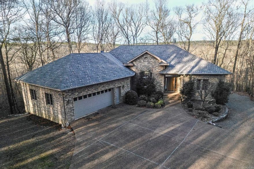 A long driveway brings you to this beautiful home situated at the edge of the Village high above the Saline River. Custom home built with volume beamed ceiling in the great room that is open to the dining room. Spacious kitchen with pull out pantry storage, breakfast bar open to the breakfast area.  Large windows bring the outside in.  Beautiful built ins with gas log fireplace in great room.  Generous primary suite in this divided bedroom plan. Third bedroom currently has built in office area. Storage galore in the laundry room. Enjoy the view from the large covered and uncovered deck.  Oversized two car garage.  Easy access to shop under home is every woodworkers dream. Private patio below allows you to enjoy the sounds of nature. Roof 2023. Heat pump 2023.  Hot water heater 2019. Privacy yet in the Granada neighborhood await you!