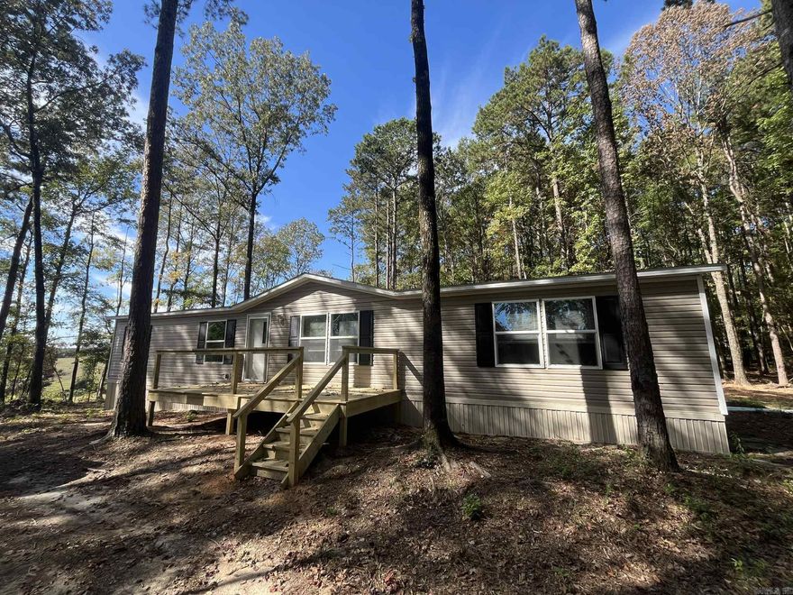 Looking for a weekend river escape or a primary residence nestled in the woods? Take a look at this well maintained double wide just minutes to the Cossatot River! The home features a spacious floor plans, 3 bedrooms and 2 full baths, central heat & air, nice natural light throughout and a small deck. Sitting on 4 acres with beautiful country views, this low maintenance property offers privacy, tranquility and easy access to the river!