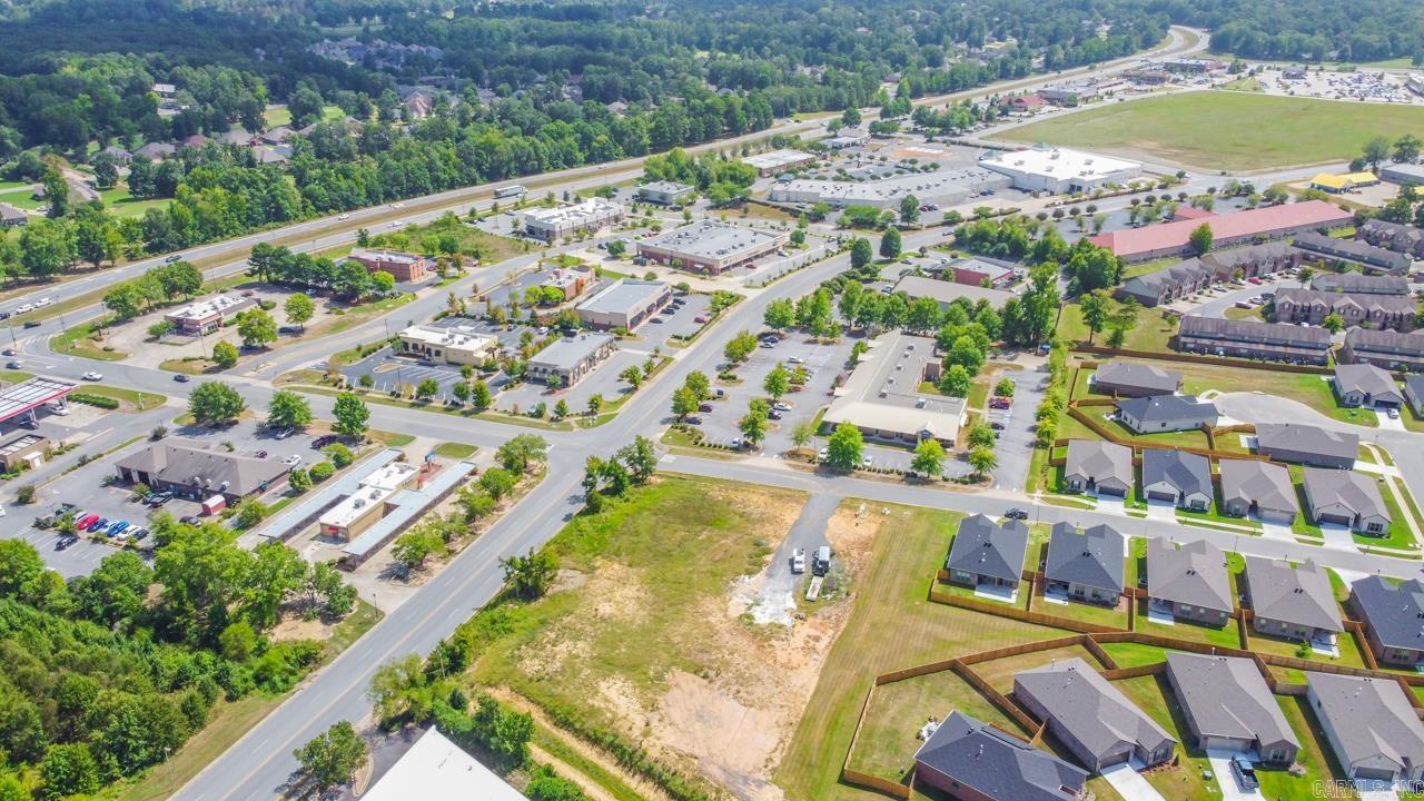 PERFECT LOCATION IN THE CENTER OF THE CITY OF MAUMELLE! EXCELLENT ROAD FRONTAGE ON BOTH CLUB MANOR AND CARNAHAN COURT! WE WANT YOUR BUSINESS TO COME AND BUILD AT THE CORNER OF CLUB MANOR AND CARNAHAN COURT. LAND IS CLEARED AND PAD READY. WE CAN REFER YOU TO AN ENGINEER TO HELP YOU WITH YOUR DESIGN OR BRING YOUR OWN! PROPERTY BACKS UP TO A NEW SUBDIVISION WITH 59 HOMES AND IS CURRENTLY NEXT DOOR TO DOLLAR GENERAL, OFFICE STRIP MALL & ACROSS THE STREET FROM MANY FAST FOOD/RETAIL LOCATIONS! MAUMELLE IS EXPANDING THIS AREA AS PART OF THE CLUB MANOR CORRIDOR TO THE CENTRAL ARKANSAS GREENWAYS PLAN. ZONED PCD WITH A APPROVED VARIANCE OF RESIDENTIAL UNITS PER ACRE. ALL CLUB MANOR FRONTAGE MUST BE COMMERCIAL ON MAIN LEVEL. CALL FOR AN ALREADY PREPARED PROPOSED DESIGN. SEE PICS FOR THE PROPOSED DESIGN.