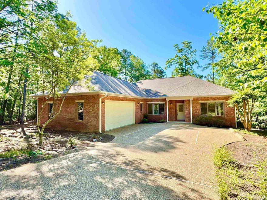 Well-maintained 3 bed, 2 bath one-level brick home near Glazy Peau Gate for convenient access in and out of Hot Springs Village. Located just minutes from multiple lakes, golf courses, hiking trails, and the Coronado Fitness Center. Features include a vaulted living room with corner brick fireplace, split bedroom layout, and a large screened porch overlooking a wooded backyard. The spacious kitchen offers abundant cabinetry, a center island, and a built-in desk. Fresh interior paint, new lighting throughout, new carpet in two bedrooms, and hardwood floors in main living areas. Primary suite includes access to the screened porch, a walk-in closet, and dual vanity bath. Oversized two-car garage and level driveway for easy entry. Enjoy quiet surroundings with the convenience of nearby amenities. First time HSV buyers have a $2000 one time buy-in fee. Call today for your private tour!