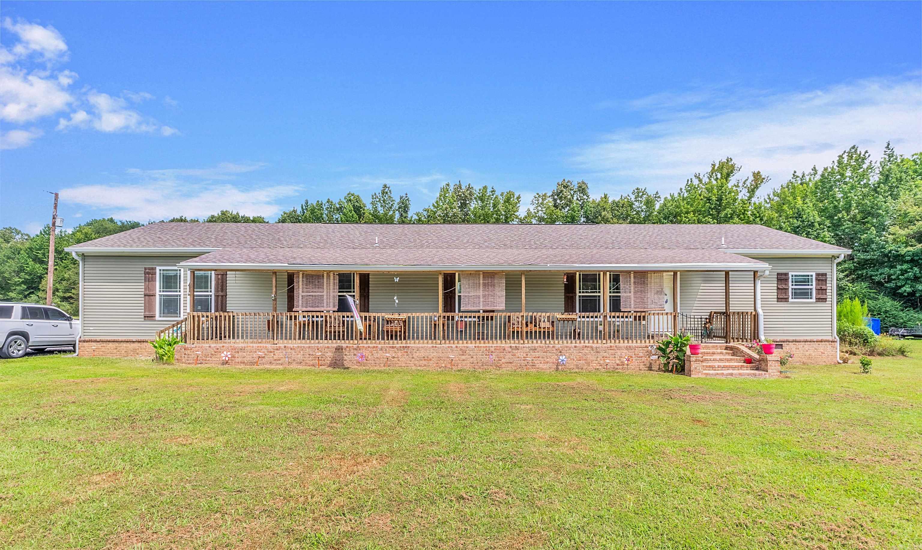 Escape to your very own private ranch with this beautiful spacious home that features 4 bedrooms, 3 full bathrooms, 2 living rooms and an open concept to your kitchen and dining. This home is surrounded by 150 +/- acres that is fully fenced and cross fenced with ponds which is the perfect set up for your cows, horses, donkeys, goats, chickens, pigs etc. There is a 30x30 shop that has doggy kennels built on the inside with a mini split attached. There is also tons of wildlife to enjoy while sitting on the front covered porch that is the full length of the home or the back deck. Come schedule your appointment to view this beautiful place to call home.