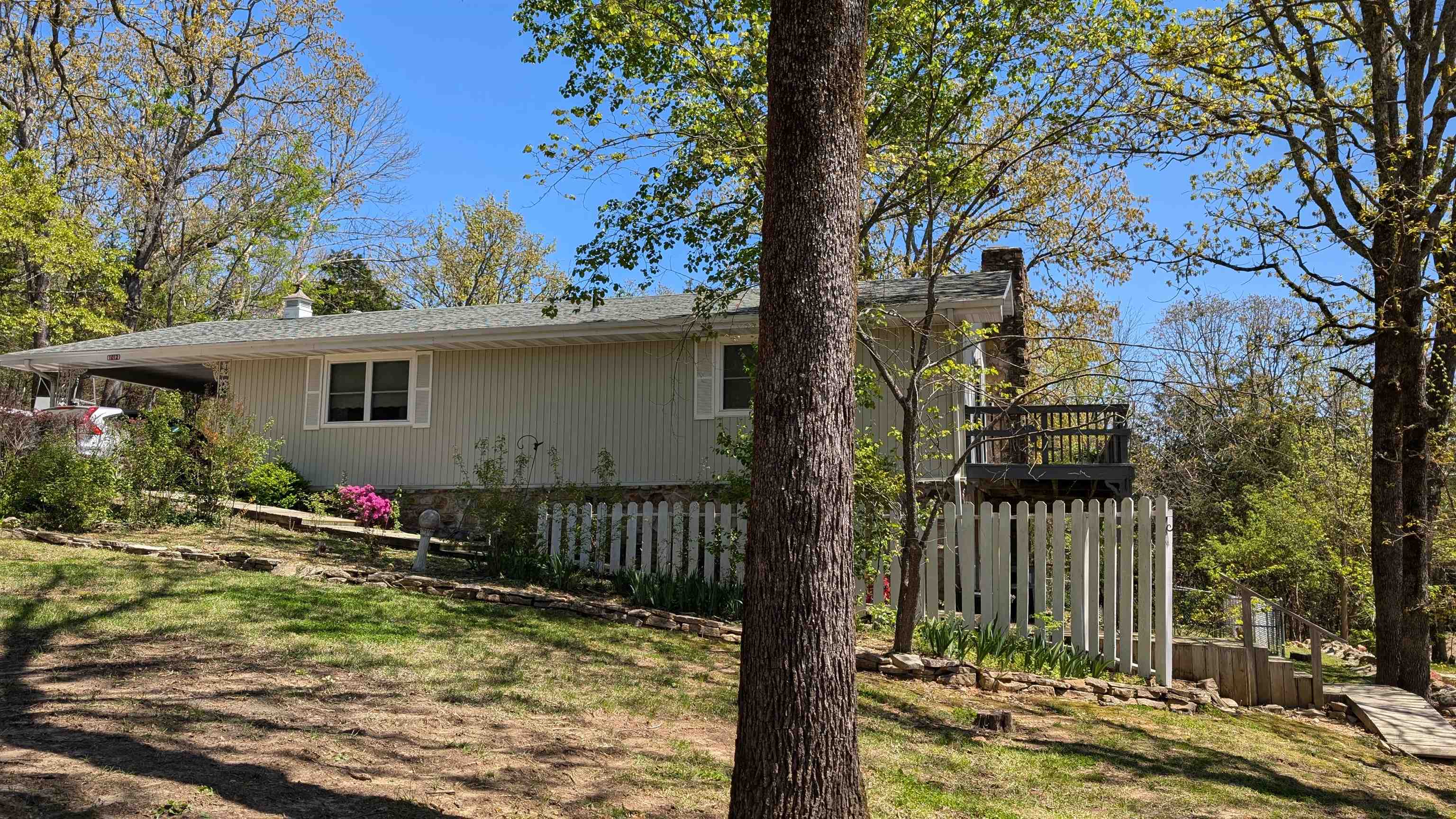 Listed BELOW Appraisal! Seasonal Lake view of Crown Lake! Step out your primary bedroom sliding door to wrap around deck to enjoy the peaceful view. Large home with large bedrooms to spread out in. Main level includes 2 beds 2 baths, open living-dining area, as well as Large kitchen with island and laundry hook-ups. Lower level has family room currently set up as 3rd bedroom, 3rd bath and a separate office space. Plus workshop area which can be accessed through the office or from the exterior, with shelves and partial concrete floor. Walk out to your lower level patio with fenced area for pets or little ones. Shed for extra storage as well as one car carport. The lot next door is included and is partially cleared. Septic lines updated, HVAC less than 5 years old as well as some appliances. If your looking for large space and a great view, then take a look at this home before it is gone! Price firm.