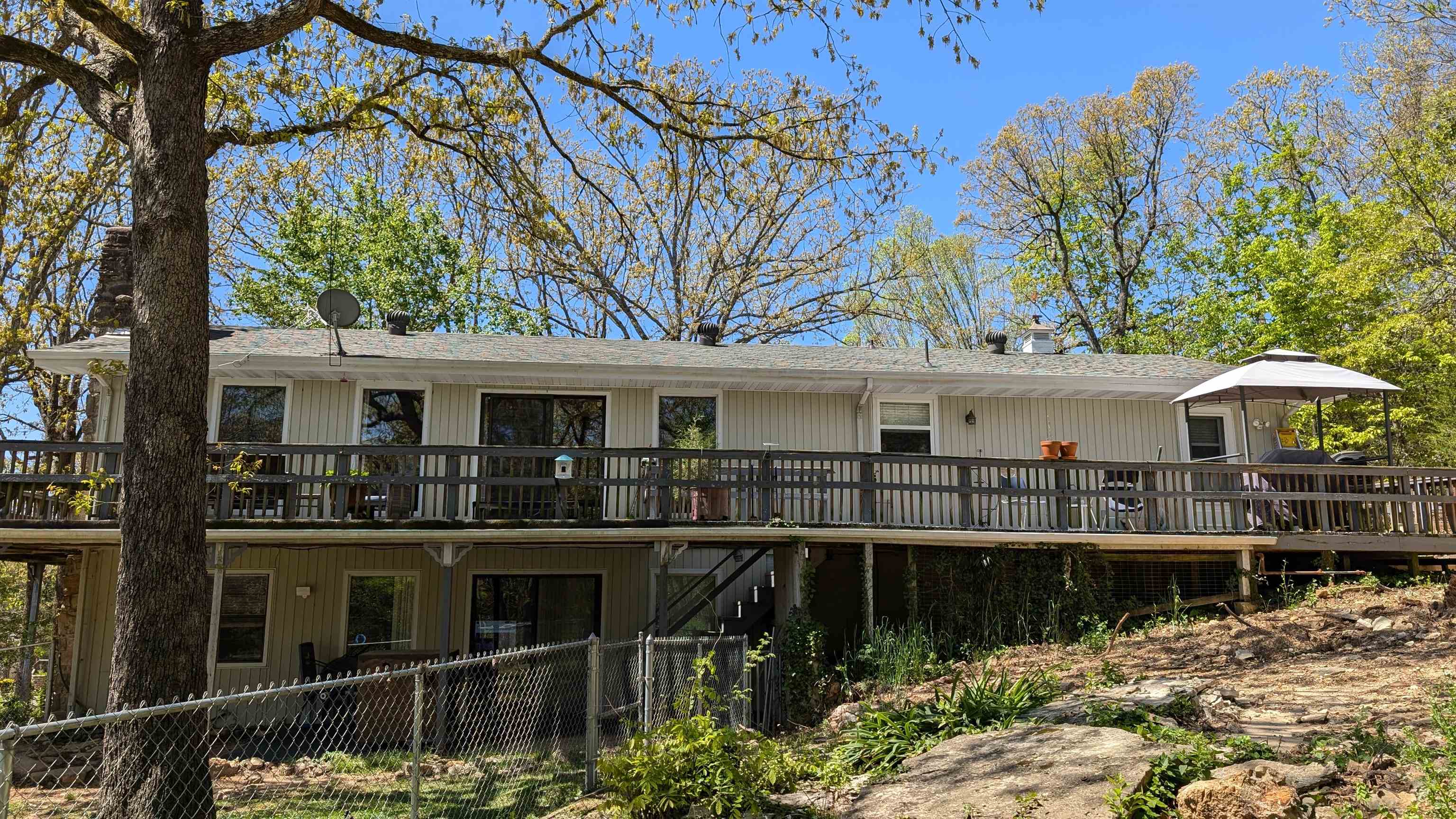 PRICE REDUCED BELOW APPRAISAL! Seasonal Lake view of Crown Lake! Step out your primary bedroom sliding door to wrap around deck to enjoy the peaceful view. Large home with large bedrooms to spread out in. Main level includes 2 beds 2 baths, open living-dining area, as well as Large kitchen with island and laundry hook-ups. Lower level has family room currently set up as 3rd bedroom, 3rd bath and a separate office space. Plus workshop area which can be accessed through the office or from the exterior, with shelves and partial concrete floor. Walk out to your lower level patio with fenced area for pets or little ones. Shed for extra storage as well as one car carport. The lot next door is included and is partially cleared. Septic lines updated, HVAC less than 5 years old as well as some appliances. If your looking for large space and a great view, then take a look at this home before it is gone! Price firm.