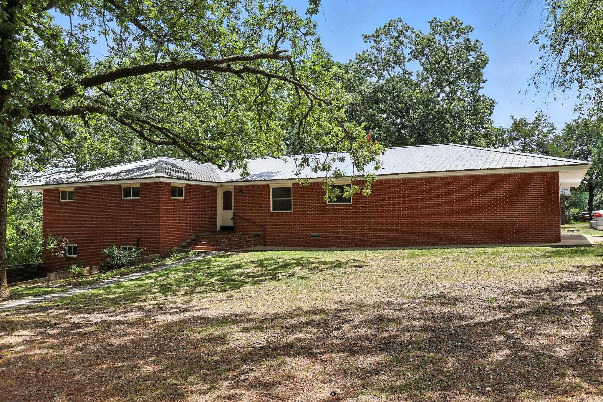 All brick family home on a large corner lot with numerous updates throughout. Light filled foyer opens to a spacious great room with dining area that flows into the kitchen. The eat-in kitchen features updated paint, new gas range and dishwasher, plenty of cabinets, and instant hot water. Newer flooring, fresh carpet, and interior paint give the home a fresh, updated look. The main level offers a primary bedroom with attached bath, plus three additional bedrooms and a full hall bath. The lower level includes a cozy family room with gas starter fireplace, a separate office, craft room, or potential 5th bedroom, full bath, and laundry room. New metal roof, solar panels, and electrical system (2020). Fully fenced backyard and oversized 2 car garage with workbench and extra storage. 269sf not included in total sf in basement. Come see!