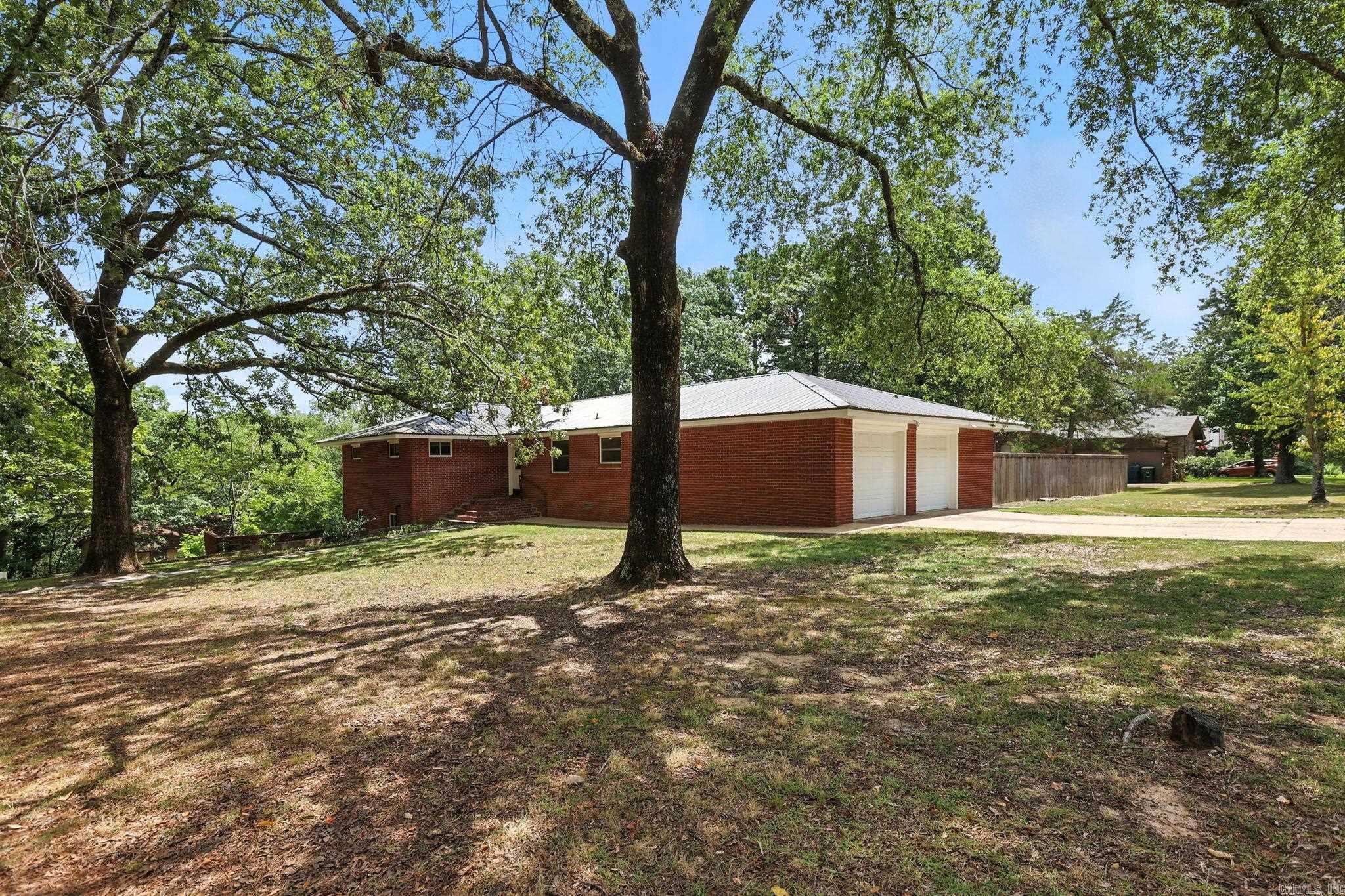 All brick family home on a large corner lot with numerous updates throughout. Light filled foyer opens to a spacious great room with dining area that flows into the kitchen. The eat-in kitchen features updated paint, new gas range and dishwasher, plenty of cabinets, and instant hot water. Newer flooring, fresh carpet, and interior paint give the home a fresh, updated look. The main level offers a primary bedroom with attached bath, plus three additional bedrooms and a full hall bath. The lower level includes a cozy family room with gas starter fireplace, a separate office, craft room, or potential 5th bedroom, full bath, and laundry room. New metal roof, solar panels, and electrical system (2020). Fully fenced backyard and oversized 2 car garage with workbench and extra storage. 269sf not included in total sf in basement. Come see!