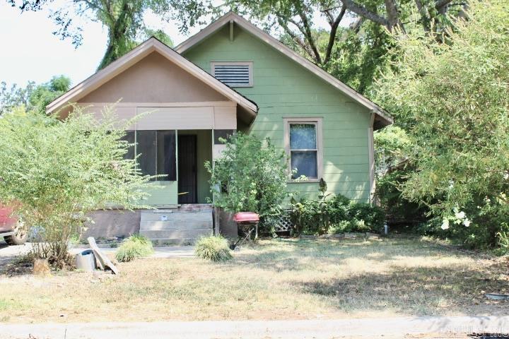 This is an investors dream! Lot's of potential and conveniently located close to UAMS. An enclosed front porch welcomes you to sit and relax outside in any season and enjoy the beautiful Arkansas weather. This home offers 2 full bedrooms with the potential for a third. Also, there is a living room and a versatile bonus room that could be used as a formal dining room, gaming room or whatever you'd like. Venture into the spacious back yard and discover a huge outside storage building nestled among towering trees. Whether you're looking for a home for yourself or you're an investor seeking a flip or rental opportunity, you owe it to yourself to check this out! Perfect location, it won't last long! AGENTS PLEASE SEE REMARKS!!!!!