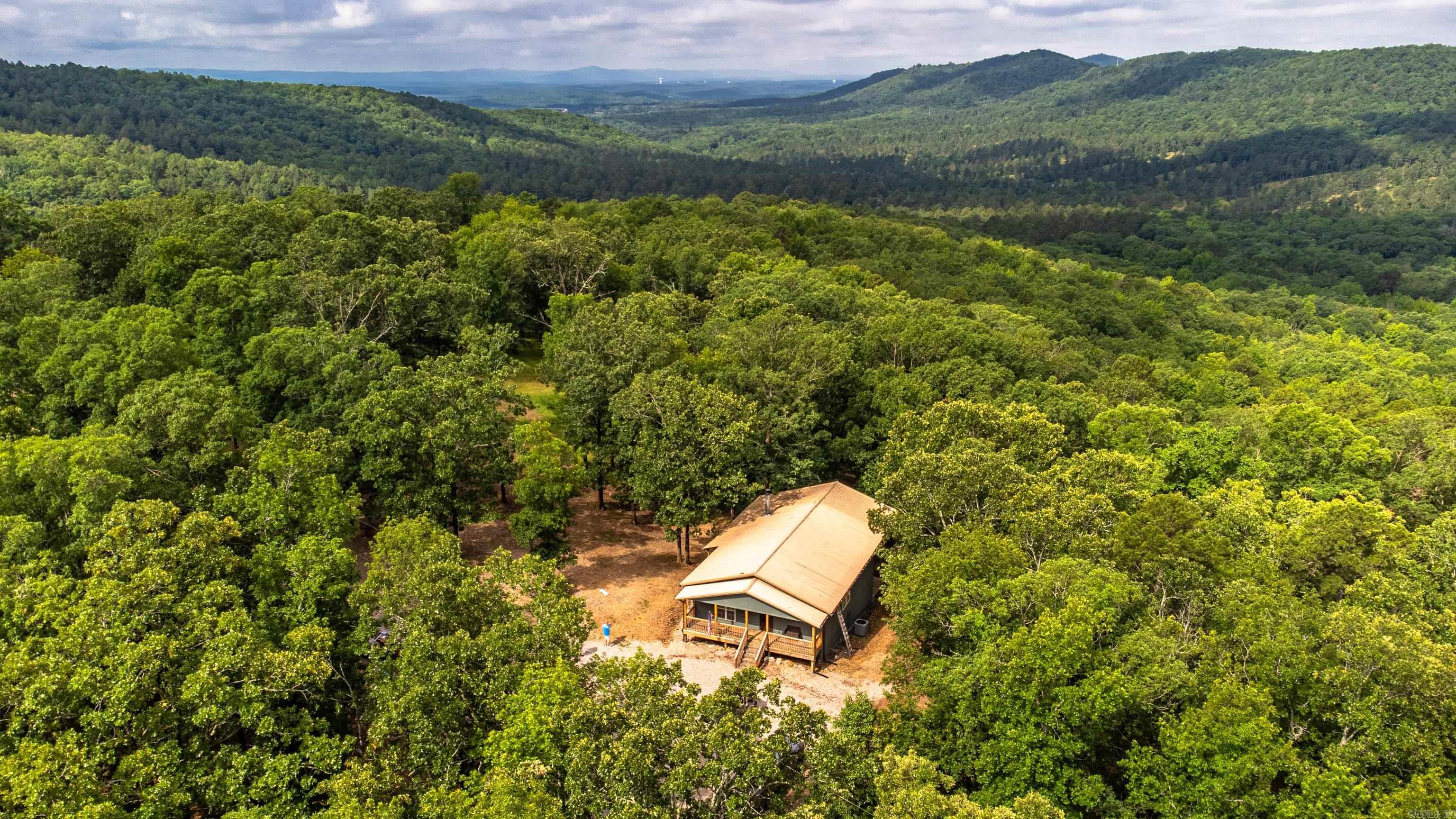 Where Rustic charm meets wide-open freedom on 49.5 acres to explore. Several creeks to wander and mountain views that will steal your heart. The property is loaded with deer and turkey making it a true outdoorsman's dream. The COMPLETELY remodeled 3 bedroom /2 bath, 2,400 sq ft home blends modern comfort with country warmth, perfect for a family craving space, freedom, and fresh air, a weekend escape for those seeking peace and privacy, or a hunter's paradise right out your back door. Enjoy a newer HVAC system (approx. 5 years old), a durable metal roof, and 30X40 shop (1,200 sqft) with two large doors-- ideal for projects, storage or man cave that any outdoorsman would appreciate. Don't miss your chance to own this rare piece of Arkansas paradise, schedule your private tour today! property has been appraised.