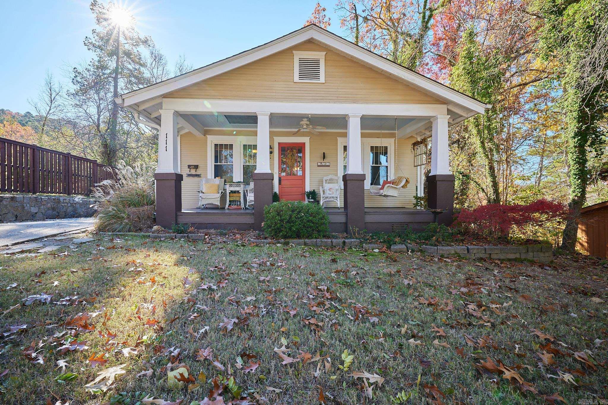 Enjoy vintage craftsman bungalow style at 111 Hillcrest Street, now available in Hot Springs, AR! This home has been lovingly updated, offering a warm, cozy atmosphere. From the covered front porch to the shady back deck, there are many spaces to relax and enjoy the breeze from North Mountain. Inside, you'll find wood floors, an updated kitchen, gas logs in the fireplace, and charming built-ins. Downstairs, a rustic den is a great place to enjoy the views or a game.