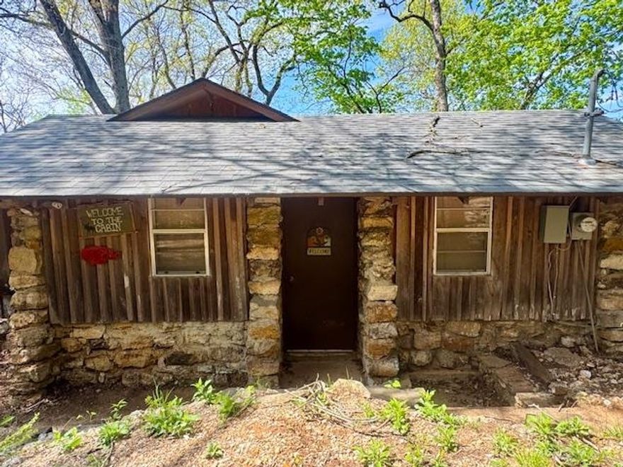Riverfront Cabin- Excellent Swimming, Fishing, and Floating! This adorable 730 sq ft cabin is located in the Old Camp Miramichee subdivision on the Southfork River. This quaint retreat features stone flooring and a durable masonry frame exterior, offering both character and durability. Enjoy direct river frontage with a spacious deck overlooking the water—perfect for relaxing or entertaining. The bedroom includes a private back porch, ideal for taking in the peaceful, natural surroundings. Imagine enjoying a cup of coffee on your porch, hearing the sounds of the river and birds chirping, and watching the people float on by while you think about all the fun you'll have on the water later that day. When the sun goes down and the stars light up the sky, the magic of this property continues. Whether you're grilling and playing games on the deck, or hosting friends and family, the memories you create will never end. This property is surrounded by scenic beauty and offers an excellent opportunity for a weekend getaway, rental investment, or full-time residence. Great location with easy access to Hardy/Cherokee Village amenities while maintaining a private, nature-filled setting.