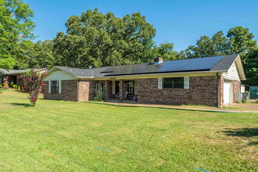 This brick corner lot home is a great find for your personal home or your short-term rental. S-T-R LICENSE IS IN PLACE! Formal living and dining with fireplace which is currently being used as a fourth bedroom. Cozy den on the back. Second oversized cooled garage that could be used as a game room, hobby headquarters, shop, storage, or a home for extra vehicles and toys. Garage has a separate entrance off of courtyard. Nice paved, fenced courtyard for your entertaining. Whole house generator with propane tank.  All bedrooms have walk in closets. With a little updating, what a place you could have for the price. Roof is partially solar panels. You can't get much closer to Sam's Pizza Pub!