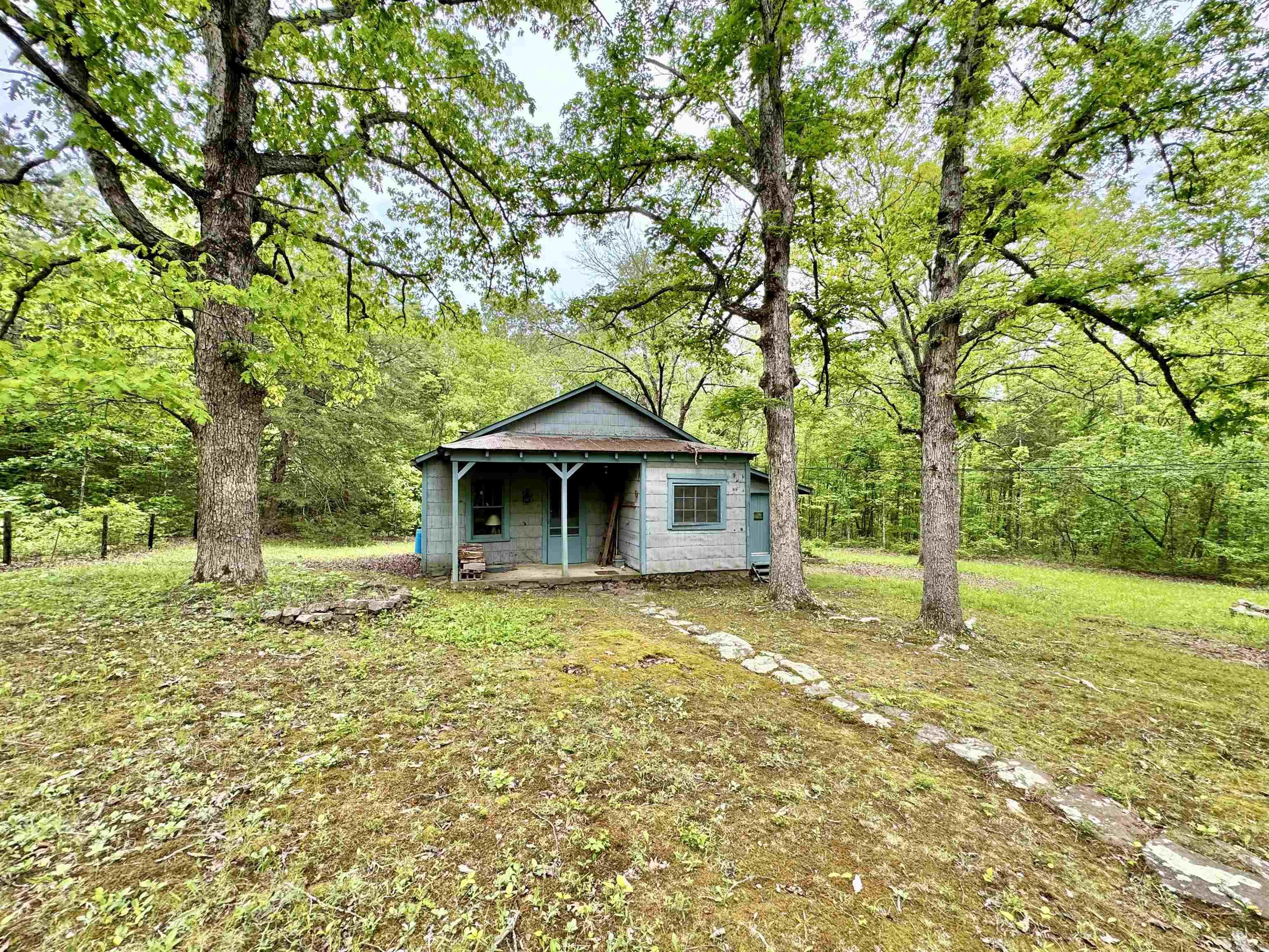 This property is an outdoorsman's dream. It is very private, with lots of area to explore, and a beautiful creek to swim, fish, or float on. The property features a cozy 2-bedroom cabin, with a storage building, as well as a dated cabin structure located on the property as a bonus, that could be of some use to someone with a little bit of fixing up. Would make a great homestead location, vacation property, or even a great place to build your dream home on in this beautiful spot in the country.