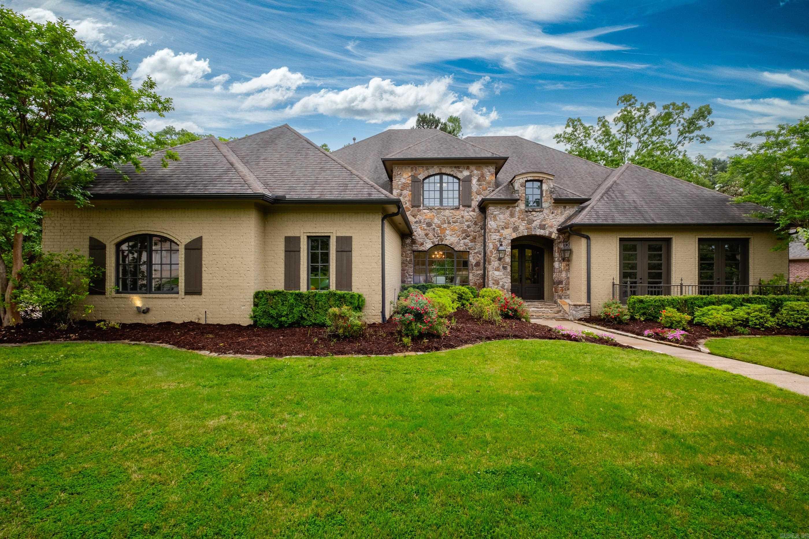 5770 sq ft, French style home completely remodeled in 2024 in a desirable gated neighborhood in Chenal. Hardwood floors throughout the downstairs. Updated lighting, quartz, marble countertops, lighting. The foyer has vaulted ceilings leading to a dining room and formal living space. The windows show views of the gorgeous outdoor space. Step outside to a peaceful large backyard with a heatable pool and spa. Built-in outdoor kitchen area has grills, mini refrigerator, and wood burning fireplace. Protected green space behind the home gives a private feel yet Chenal Country Club is a 3–5-minute golf cart ride away. The master has a spa like bathroom, his and hers vanities and large walk-in closets. The kitchen is perfect for entertaining. Under mount electrical and lit cabinets. Downstairs has a huge family room with a built-in bar, office space, large laundry room, mud room with locker space and desk. Upstairs has 3 bedrooms & 2 bathrooms, theater room with projector and seating.