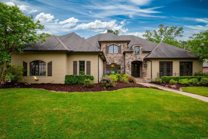 5770 sq ft, French style home completely remodeled in 2024 in a desirable gated neighborhood in Chenal. Hardwood floors throughout the downstairs. Updated lighting, quartz, marble countertops, lighting.  The foyer has vaulted ceilings leading to a dining room and formal living space.  The windows show views of the gorgeous outdoor space. Step outside to a peaceful large backyard with a heatable pool and spa.  Built-in outdoor kitchen area has grills, mini refrigerator, and wood burning fireplace. Protected green space behind the home gives a private feel yet Chenal Country Club is a 3–5-minute golf cart ride away.  The master has a spa like bathroom, his and hers vanities and large walk-in closets.  The kitchen is perfect for entertaining.  Under mount electrical and lit cabinets. Downstairs has a huge family room with a built-in bar, office space, large laundry room, mud room with locker space and desk.  Upstairs has 3 bedrooms & 2 bathrooms, theater room with projector and seating.