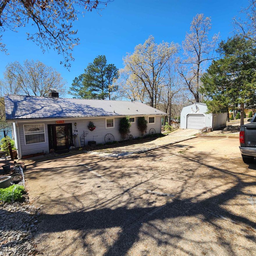 Beautiful, Lakefront home with outstanding updates. This home comes with 2 lakefront lots and well over 150' of waterfront. This is a must see 4-Bedroom, 2-bathroom home, one bathroom has a heated towel rack and vanity with courtesy night lights. Metal roof and vinyl siding. Large storage building plus storage all over inside the home as well as outside. Small workshop in back shed and a bigger workshop in larger one out front. 3 beds and 1 bath on main level along with kitchen dining and living room with gas log fireplace Stair/chair on the stairwell goes down to the lower level where you will find 1 bedroom with a sliding glass door out to the lake, 1 bathroom and a wood burning fireplace in the large living room. There is also a kitchenette and two large storage areas on the lower level. This is a must-see to appreciate home. Come see all it has to offer with its full-length sunroom across the lakeside of the main level and a full-length covered patio on the lower level where you can take a walk down to the lake and sit on the dock and wet a line or a toe or two. Make an appointment today to see this wonderful Lake Navajo home.