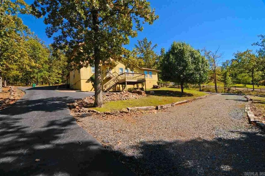 Move in Ready!  Very clean well maintained Contemporary/Traditional Home!  All wood laminate floors with exception to stairway.  Open Floor plan with nice large kitchen with island, breakfast bar and plenty of cabinet space!  Beautiful windows all over home with magnificent views!  Nice large Great/Bonus room...currently used for Theater room!  Master BR Down!  Lovely natural setting in the country a very short distance to city!  Screened in Back Porch, circle drive and Storage Bldg.