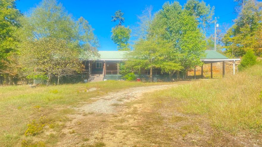 Great hunting and lots of privacy! This home sits on 27.5 acres with a wet weather creek, lots of trees and nature opportunities ! Hunting lease on west and north sides can potentially expand your hunting area! Log exterior with a covered front porch across the front of the home! Short trip down to the river and Lake Norrell boat ramp is just minutes away! Rustic interior with nice kitchen, bedroom and bath arrangements! This home has also been made handicap accessible! See Agent Remarks.