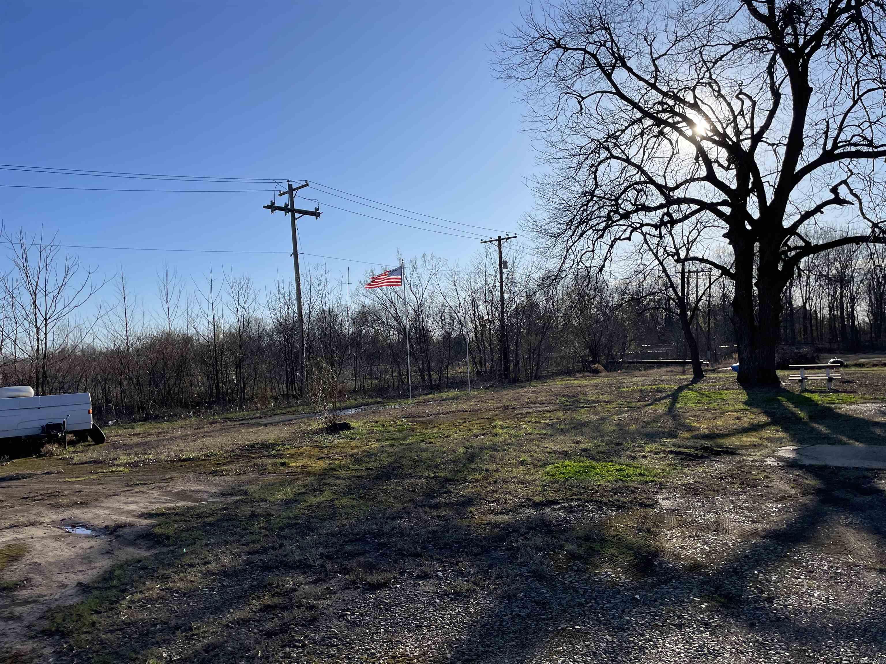 This lot has electricity and city water and sewer. It is in the 100 year flood zone area. Currently has a camper on it but will be moved.