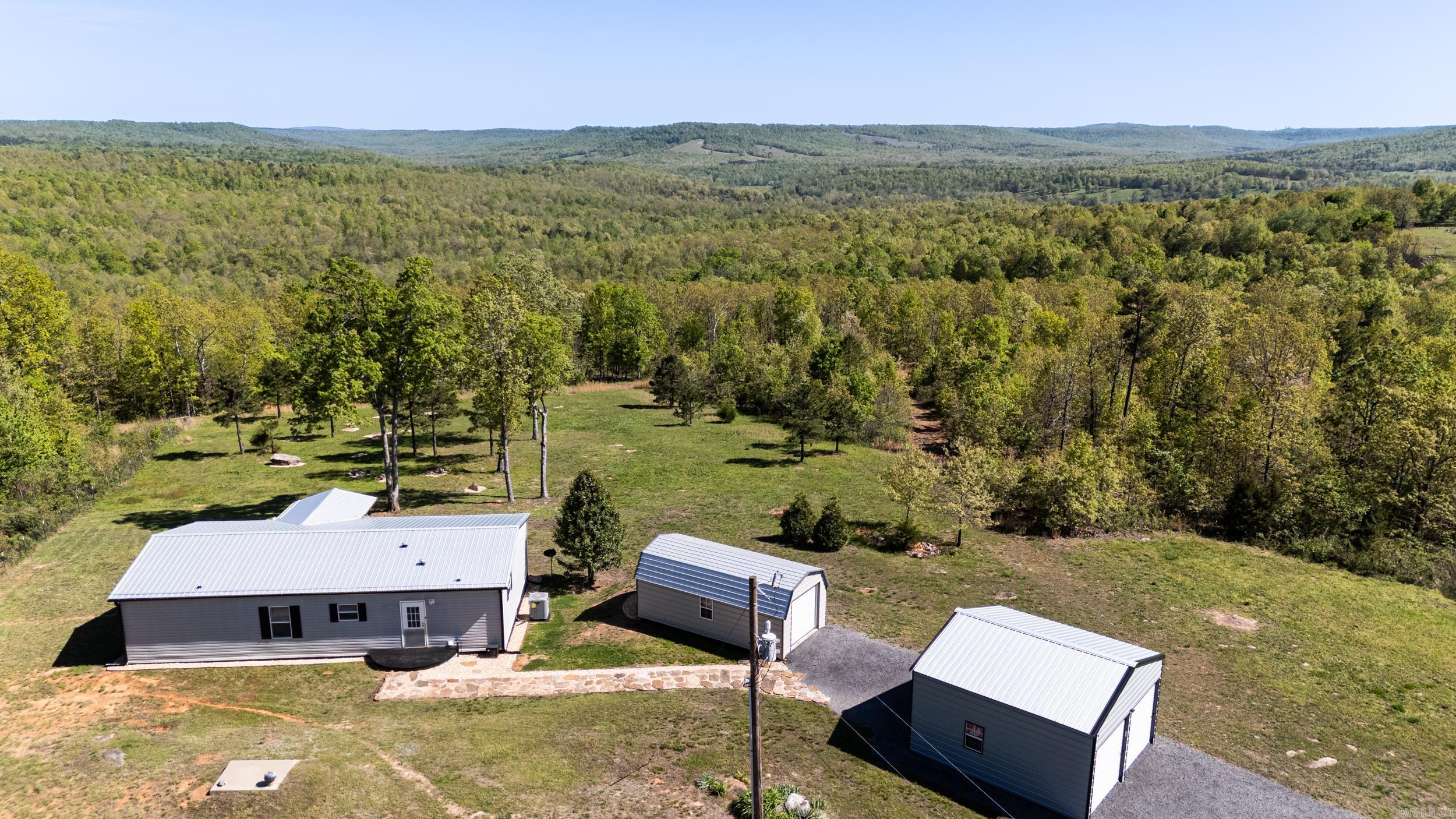 Welcome home! Donāt miss your chance to own 140 secluded & peaceful acres off a paved road with a well-maintained home and high-speed fiber. Catch catfish in your STOCKED POND, ride ATVs through miles of TRAILS, search for arrowheads, and watch deer graze in your backyard. Breathtaking views of the rolling hills of the Ozark Mountains from all over the property. Over 100 acres of hardwood timber with a seasonal branch running through it. Most of the land is fenced & has a fire break. 13 acres are fenced with road-front gated access enclosing the pond for possible pasture use. Gated entrance. 2-car garage. workshop/shed. NEW A/C in 2023. Metal roof, metal skirting, metal gutters, 30-year flooring, SS appliances, W/D, modern lighting & plumbing fixtures & sinks all within the last 2 years. Super low taxes. Walk-in closets in every room. Beautiful flooring throughout the home and an amazing view from the back deck. Updated appliances in kitchen and large living area. For peace of mind, this property has a storm shelter, supplemental propane heaters, alarm system, and is wired for a whole-house generator. Home comes mostly furnished. Ask for complete list. Schedule your showing today!
