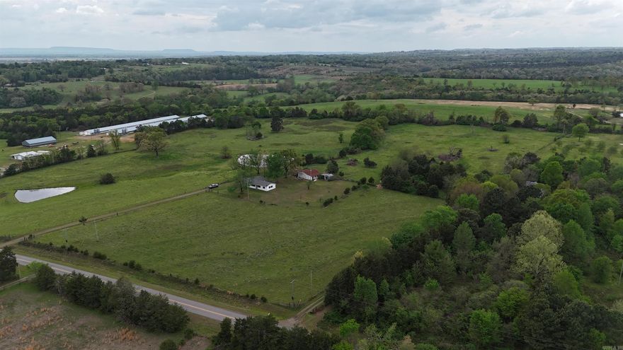 Midwest Land Group is pleased to present this 31.5+/- acre cattle farm, including a residence, to the market.  The property features well-maintained, fenced, and cross-fenced pastures. A cattle working lot is present and could be readily returned to use with some clearing. Amenities include a concrete waterer supplied by an existing well. Two ponds, stocked with fish, are located in the south paddock. A grazing lease is currently in place on the pasture, which is subject to termination or continuation by the new owner.  The residence is a well-maintained four-bedroom, two-bathroom home. It features a spacious living room and den area, with a combination of hardwood and vinyl laminate flooring. The entire interior has been recently repainted and is prepared for immediate occupancy. The exterior is finished with steel siding and includes a chain-link fenced area on the north side of the home. The yard is neatly kept, with Zoysia grass present in the front of the residence.  Also included is a one-car carport attached to the home.  The backyard boasts large shade trees, providing an ideal setting for relaxation while observing children or enjoying a sunset. Furthermore, the property i
