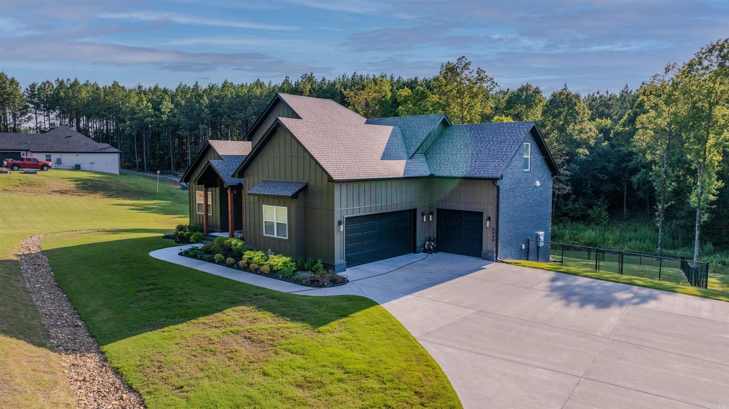 This stunning 3,850-square-foot home offers the perfect blend of space, comfort, and natural beauty. Nestled on over 2 acres of landāone acre of which is professionally soddedāit provides both privacy and room to enjoy the outdoors. The wooded backyard creates a serene setting, ideal for relaxing or entertaining. Inside, the home features four spacious bedrooms and three full bathrooms, with two bedrooms conveniently located on the entry levelāperfect for multi-generational living or guest accommodations. The open-concept layout highlights generous living areas filled with natural light, and high-end finishes throughout. A highlight of the property is the 800-square-foot heated and cooled walk-out basement with patio, offering versatile space for a gym, or home office. The three-car garage provides ample storage and convenience for vehicles, tools, and outdoor equipment. Whether you're enjoying the expansive green lawn, hosting gatherings in the spacious living areas, or the peaceful wooded backdrop, this home is thoughtfully designed for both comfort and functionality. Ideal for families or anyone seeking space, privacy, and quality craftsmanship in a beautiful natural setting.