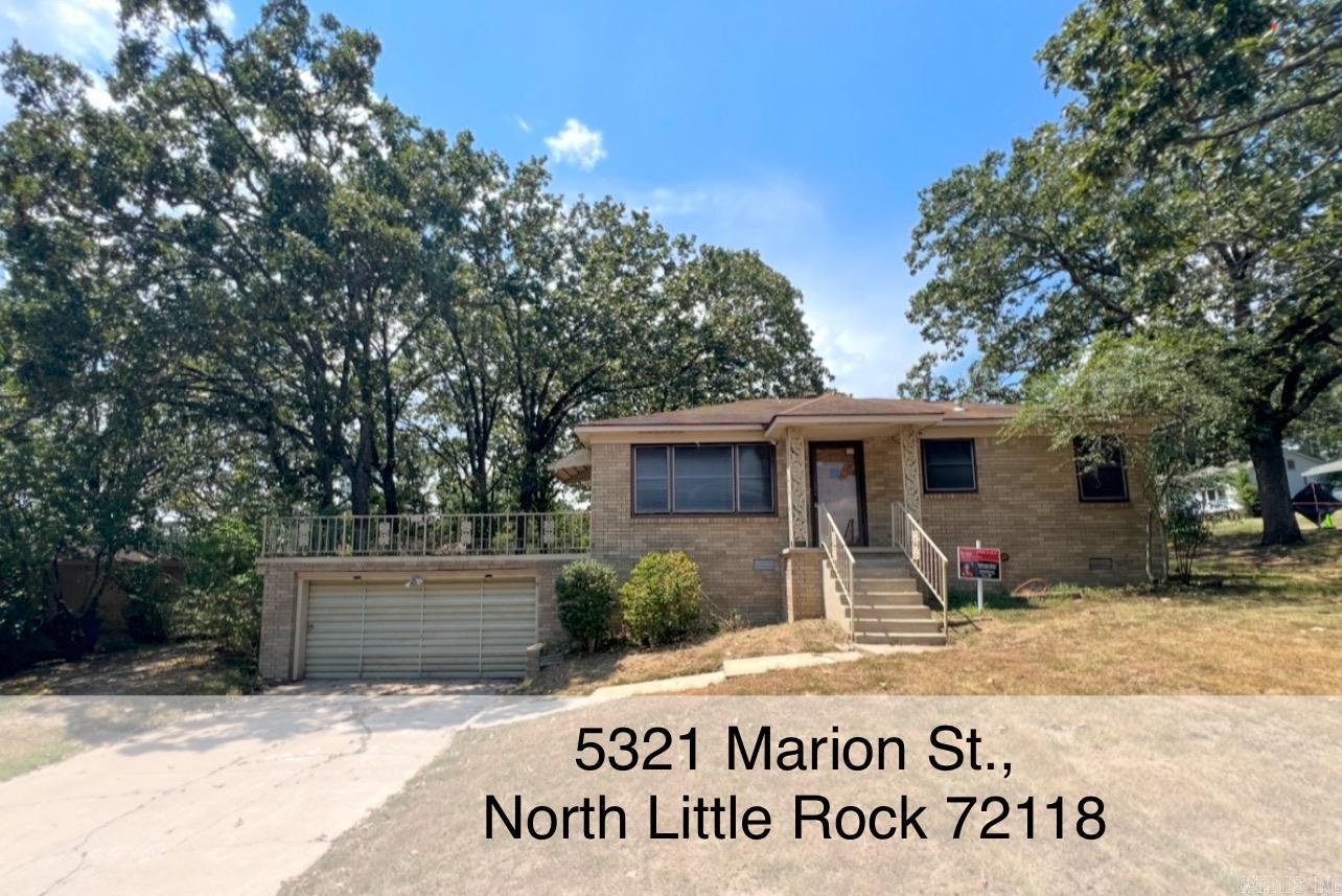 5321 Marion Street. Discover this all brick single family home, full of curb appeal on a corner lot! Step through the stunning front door that sets the tone for the warm and inviting interior! Featuring original wood floors throughout, this 3 bed, 1 bath home offers cozy living spaces with all new interior lighting. Step outside and enjoy the unique patio above the 2 car garage, perfect for relaxing or entertaining. Fully fenced backyard is shaded by mature trees. Low Maintenance! New Air Duct System 2024, Water Heater 2025, New HVAC 2021. Exterior has been power washed to look like new! Don't miss out on this charming all-brick home! VIDEO TOUR AVAILABLE: https://tinyurl.com/bxn24k6a