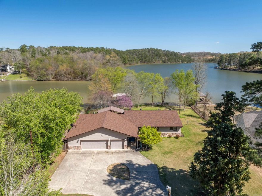 Wow! A single-story, 4 bedroom home sitting on a large level-lot on Lake Hamilton with a covered boat slip, swimming deck, fenced in backyard and large covered patio?? Rare is an understatement. So many selling features including a three-Car Garage, Two Laundry Rooms, gorgeous views of Lake Hamilton from every bedroom, and 150 feet of lake frontage!