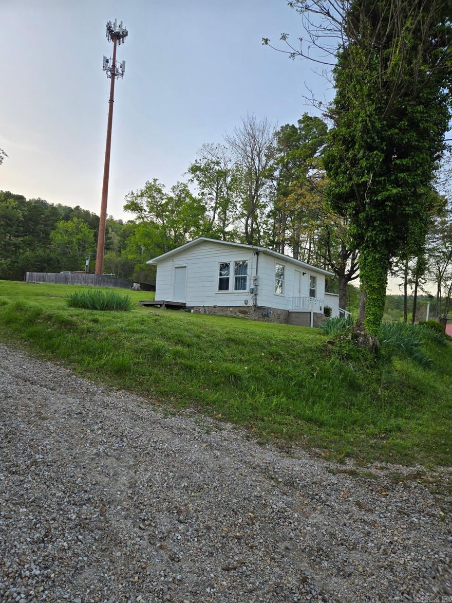 Charming Cottage Retreat with Rare STR Potential – Over Half an Acre! Tucked away at the end of a quiet private road, this cozy cottage sits on a generous 0.56-acre lot (Lots 4–7 and part of 1-2) and offers peaceful surroundings with a circular drive for easy access. The home is solid and well-maintained, featuring recent updates to plumbing, electrical, and the bathroom—plus a brand-new roof installed in January 2025.  The property is zoned Commercial-Residential, making it eligible for the rare and highly sought-after city's Short-Term Rental (STR)—perfect for investors or those seeking a charming vacation home with income potential.   Looking for more space? An adjacent 0.7-acre parcel (Lots 1–3) is also available, backing up to Hot Springs National Park land for direct access to natural beauty and endless recreation. See MLS #24035147 for details.