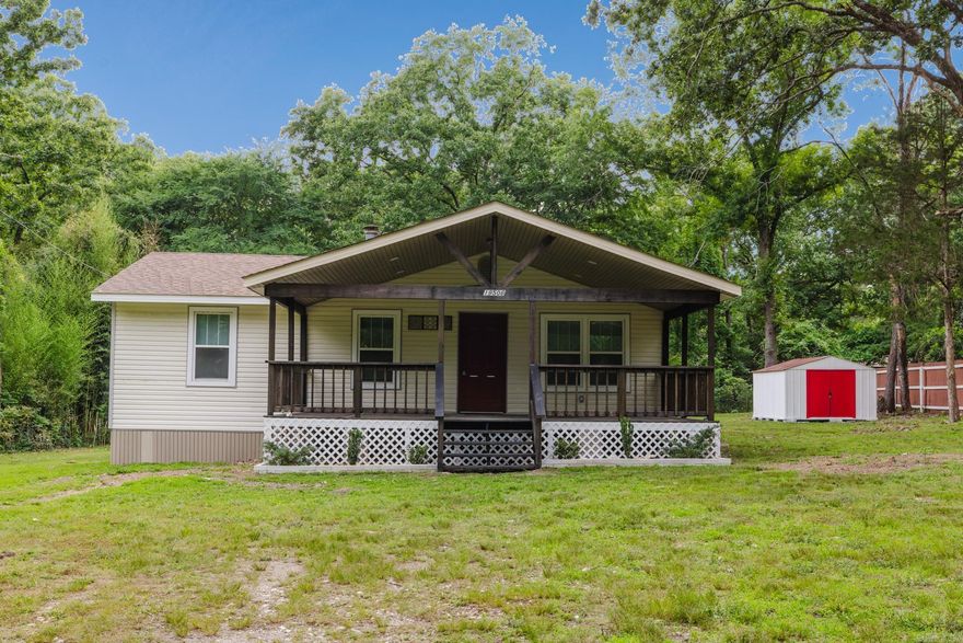 Take a look at this beautifully renovated home tucked away on a spacious lot surrounded by mature trees and peaceful privacy. This move-in ready property blends modern updates with country charm, featuring a large covered front porch perfect for relaxing mornings or evening gatherings. Inside, you’ll love the open layout with updated luxury vinyl flooring, fresh neutral paint, recessed lighting, and abundant natural light throughout. The kitchen has been refreshed with white cabinetry, granite countertops, stylish backsplash, stainless steel appliances, and a convenient breakfast bar opening into the living space for easy entertaining. Sliding glass doors lead to the backyard and bring the outdoors in.  The oversized yard offers endless possibilities for entertaining, gardening, pets, or future additions, plus a storage building that conveys. Located just minutes from Little Rock while still offering a quiet retreat feel, this home is ideal for buyers looking for updated finishes, space, and affordability all in one. Don’t miss your chance to own this beautifully updated property with modern touches and room to grow!