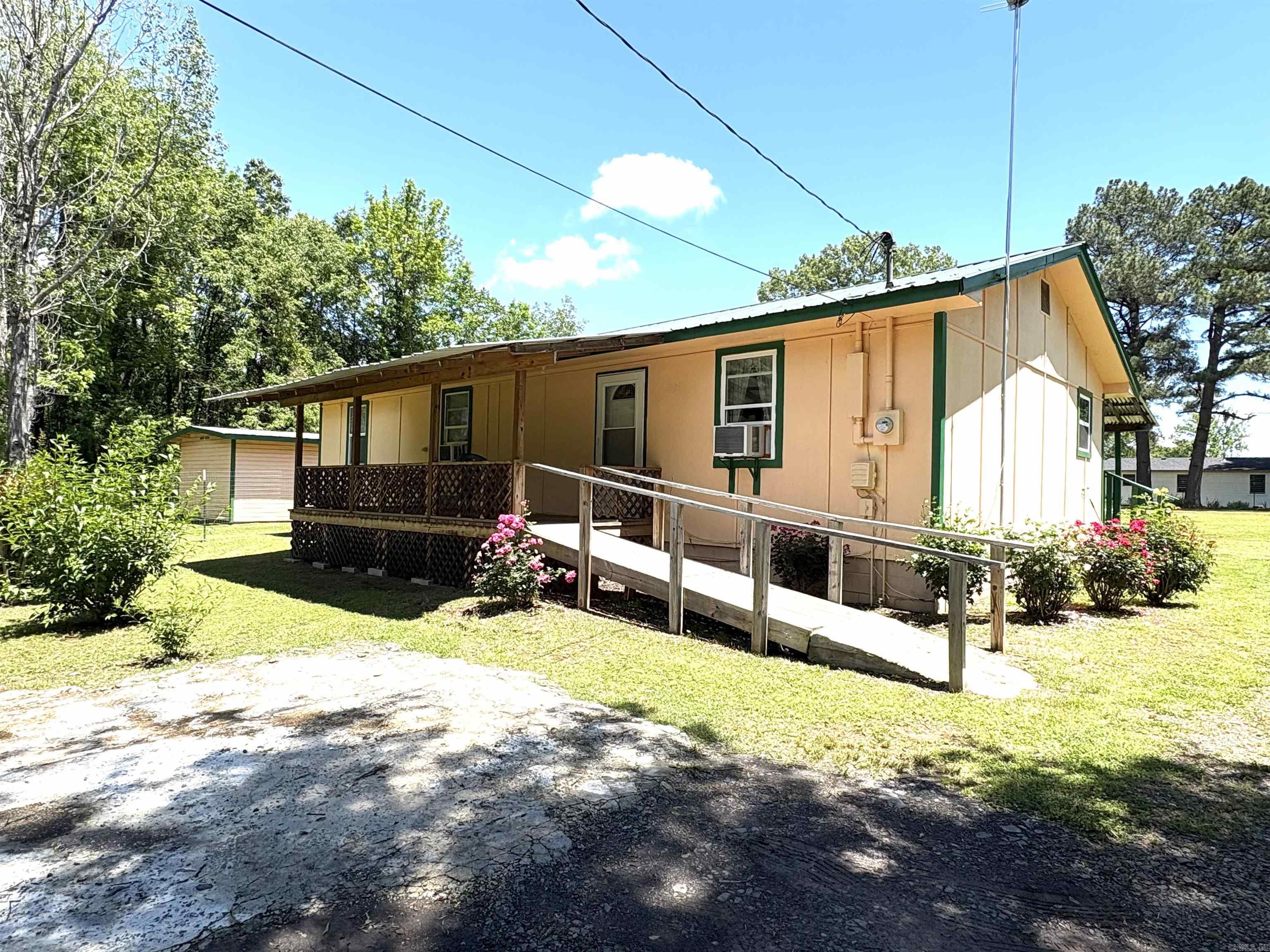 Cozy 3 bed, 1 bath home with a well-maintained interior, new kitchen cabinets and countertops and all laminate flooring for easy cleaning! Great outdoor spaces on this .53 acre, large backyard with perfect garden spots and an outdoor building for extra storage. Covered front and back porches. A little slice of country living while just inside city limits. Seller elects to sell AS IS