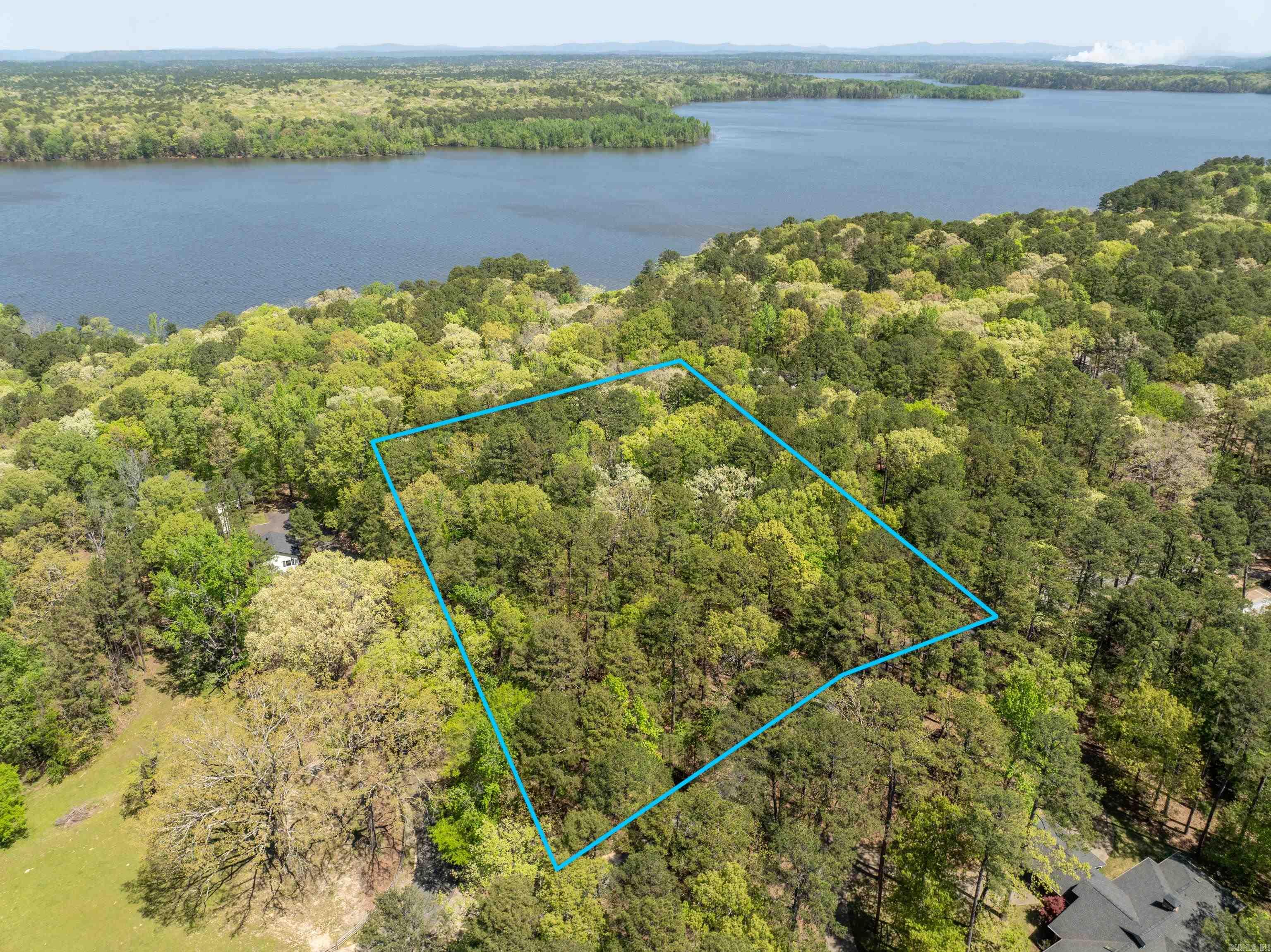 This 2.85± acre lot is located within the gated Silver Point Subdivision in Mount Ida, Arkansas, and features scenic views of Lake Ouachita. This lot borders U.S. Corps of Engineers land, so you walk right down to the lake-no crowds, just you and the water. The subdivision offers a variety of amenities, including a swimming pool, paved roads, and convenient access to outdoor activities such as boating, fishing, and hiking. 1.2 miles away, the Twin Creek Recreation area has a public boat launch, swim beach, campground, and fishing pier. The Lake Ouachita Vista Trail (LOVIT) is also nearby - a favorite for hikers and mountain bikers. 15 minutes to Mount Ida. 30 min to Hot Springs.