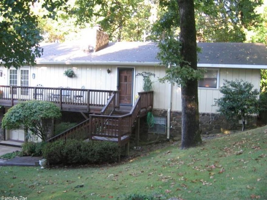 This awesome home sits on CHARTER LOT--take advantage of lower dues!!  A front-to-side-to back wrap deck expands outdoor living space, & has seasonal lake view.  Inside the living-dining room, large windows let that outdoors setting flow right in!  The entry leads to large Master, a Guest BR/Ba, Laundry Room & small office nook. All kitchen appliances included; countertops are a Wilson finish, light colors.  Gas F/P.  Lower level partially finished with shop & tons of good storage.  1-car garage. RV storage