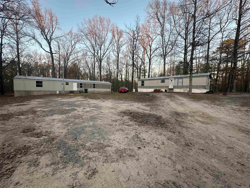 INVESTMENT PROPERTY! Both Homes Have Been Completely Updated! New Floors, Fresh Paint, New Lighting, And So Much More! This Property Has (2) Mobile Homes Currently Sitting On 4.8 Acres Of Land. 3 BR 2 BA & 2BR 1BA - The Two Bedroom Currently Has A Tenant That Will Convey With Home- Paying $675/Mo. The Third Bedroom Will Rent For $800-$1,000/Mo.  There Is Also Plenty Of Room For Additional Dwellings To Be Added!