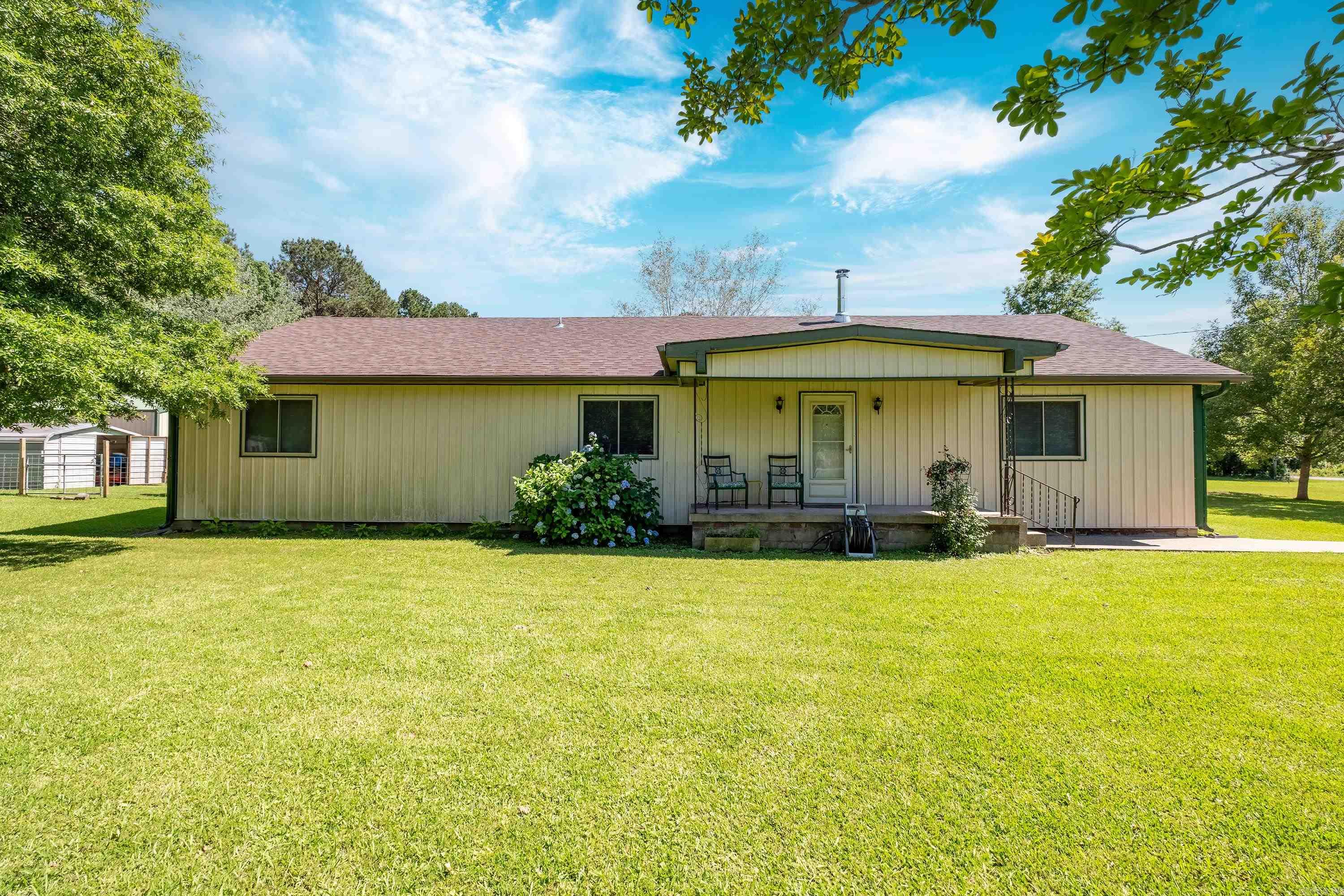 This well-maintained 4-bedroom, 2-bath home sits on a spacious 1.55-acre lot already equipped with several raised beds for gardening, offering plenty of room both inside and out. The interior features generous bedroom sizes, including the master bedroom, with his-and-her closets, and a large kitchen and dining area, perfect for everyday living. Most of the home has beautiful hardwood floors and has been recently updated with a brand-new wood-fired stove, providing warmth and character. In 2024, a new architectural shingle roof was installed, offering lasting durability and curb appeal. Step outside to enjoy the screened-in patio, ideal for morning coffee or relaxing evenings. The property also includes a garden with several raised beds, a workshop, an additional storage building, and a charming old-fashioned outhouse that adds a touch of rustic charm. With practical updates, comfortable living space, and room to spread out, this property is ready for its next owner. Call today to schedule your showing!