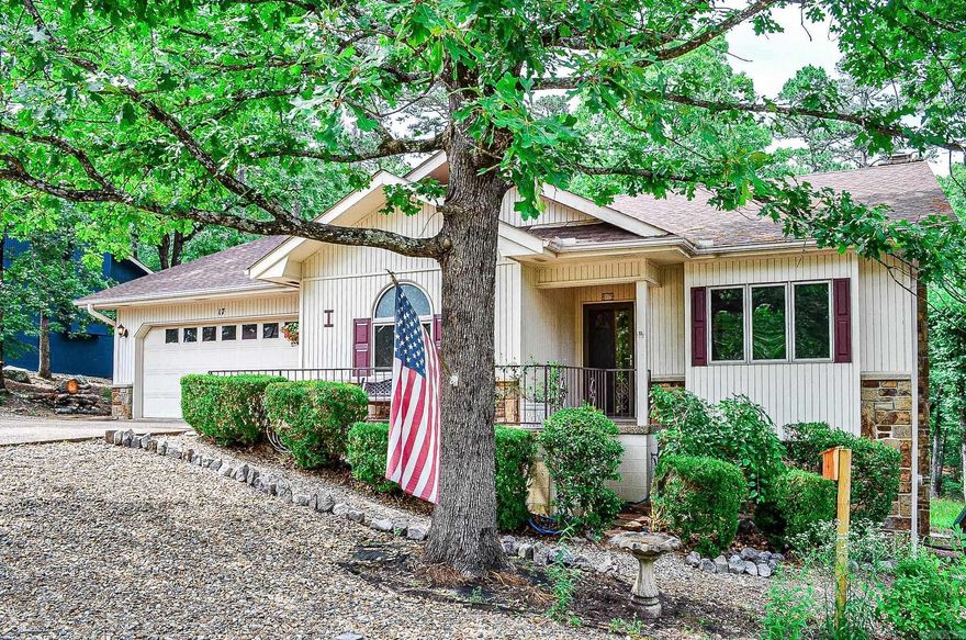 Immaculate "Vuesta" floor plan with beautiful Arkansas room overlooking private wooded view. This 3 bedroom 2 bath home also offers a screened porch and a heat/cooled hobby/bunk room which could double as a safe room in a storm. Special features include vaulted ceilings, wood burning fireplace, oodles of storage and abundant natural light from the many Peachtree casement windows.  Hardwood floors, step in shower in primary bath and location, location ,location are just a few of the home-owner favorites. Deck has been expanded for easy outdoors entertaining. Roof replaced 2024. Hot Springs Village Property Owners Association has a new-member buy-in fee of $1,500.00 due and collected at closing.