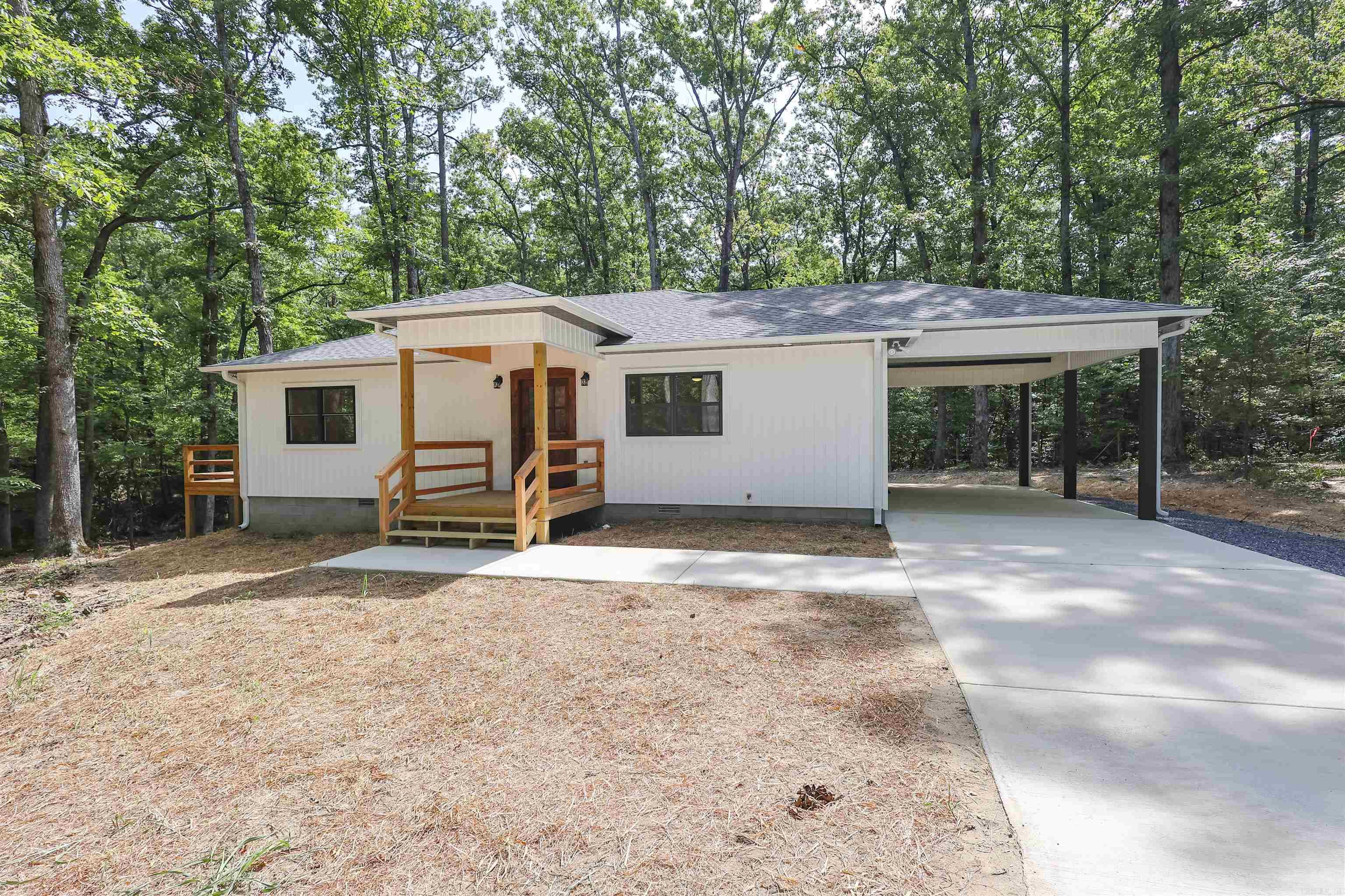 New construction by R Meeks Construction in the Townwood Subdivision. This all-electric 3-bedroom, 2-bath home offers approximately 1,408 sq ft of living space on a ±0.65-acre lot with city water and city sewer. Features include spray foam insulation, LVP waterproof vinyl flooring throughout, custom poplar cabinets with soft-close drawers, and a freshly poured concrete driveway. The primary suite includes a walk-in closet and a tile walk-in shower. Additional amenities include a treated wood deck, a carport, Frigidaire kitchen appliances, a 50-gallon Bradford White water heater, and a Tempstar 2.5-ton heat pump. Exterior features vinyl board and batten siding, aluminum soffit, and 30-year architectural shingles. Conveniently located just minutes from Mount Ida, approximately 10 miles from Lake Ouachita, and near the Twin Creek boat ramp. Relax on the deck and enjoy the sounds of nature. This is a must-see!