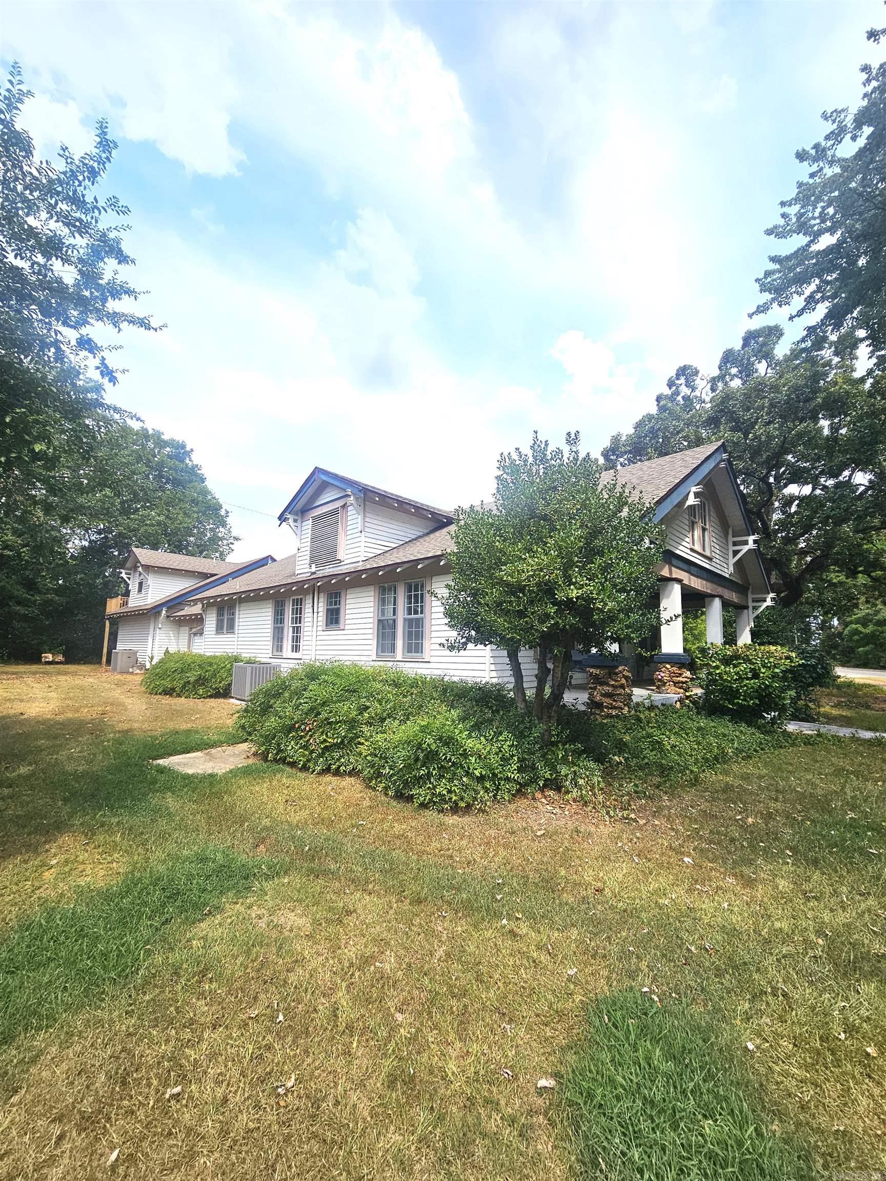 This Charming Craftsman Home on 2.2 Acres offers 4BR/3BA's, and a blend of classic character with modern updates. A two-story addition completed in 2014-2015 expands the living space, while a brand-new deck (2025) provides the perfect spot for outdoor enjoyment. The large kitchen features tile countertops and backsplash, a farmhouse sink, and under-cabinet lighting and a large pantry area. Additional rooms include a formal dining area, office/bedroom, game room, and two spacious living areas for relaxation and entertaining with two cozy fireplaces. Primary bedroom with double closet, space and updated roll in shower in (2015) plus heated tile floors in primary bathroom. Upstairs, you will discover a versatile living space with a bedroom, bath, and private sitting area and access to the deck, plus an unfinished area ideal for customization. Outdoor amenities include RV Barn (50 amp) and additional 30-amp site. 20x50 shop Shop/storage building with covered garage area for additional vehicles. Room addition on home includes foam insulation.