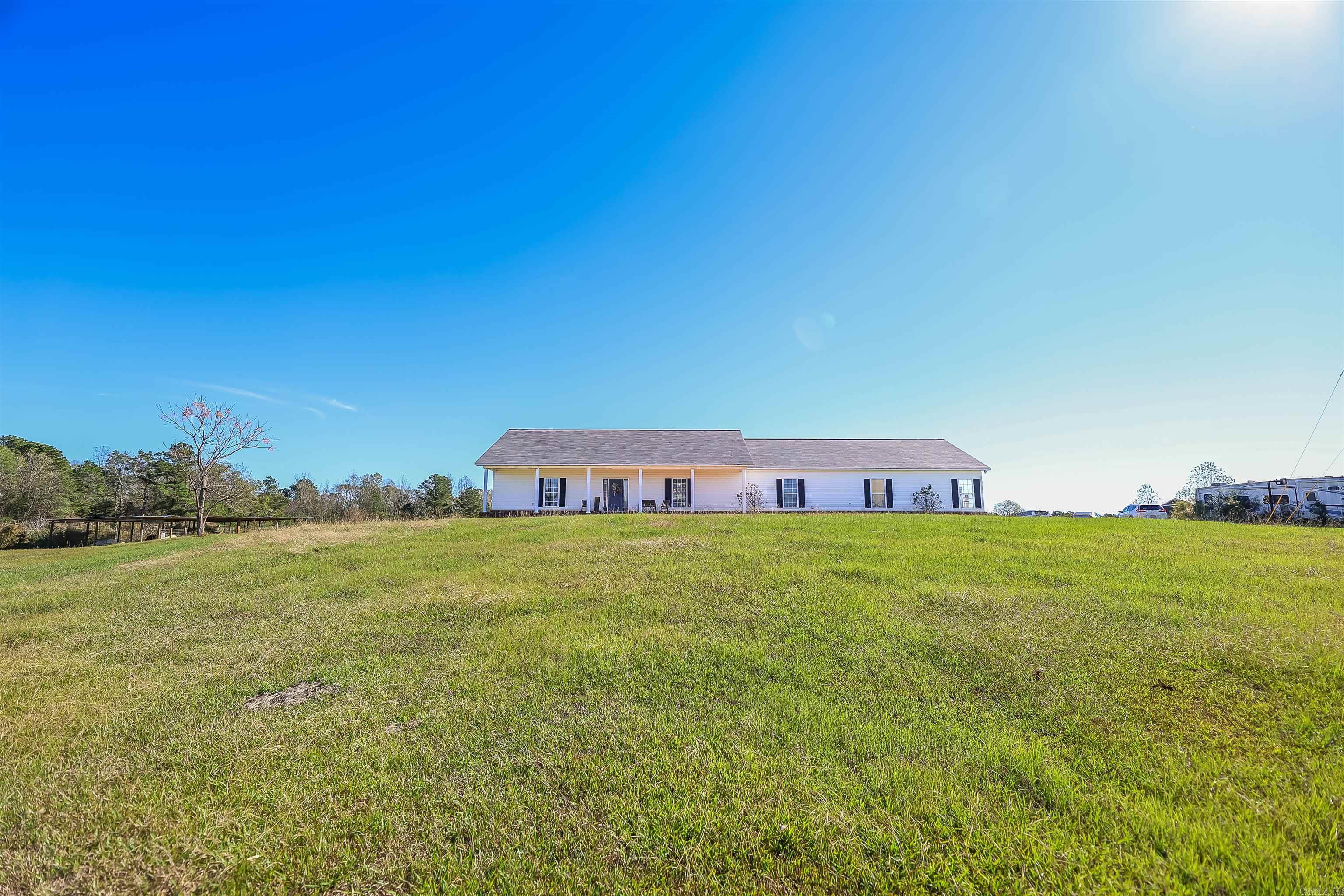 Countryside custom home sitting on 2 acres in the Fairview area. Built in 2007, the open-concept design creates an airy, welcoming feel. The spacious living areas are warmed by the natural light, enhancing the blend of function and traditional beauty throughout. From the kitchen, enjoy a breakfast nook and formal dining area surrounded by wood cabinetry and thoughtful layout. The primary bedroom offers a more elevated space with two walk-in closets and generous bathroom with additional linen closet. Want to enjoy your morning coffee in privacy? The primary suite has its own covered patio separate from the one that overflows from the living room. Don't miss the laundry room which includes another full bathroom to serve the fourth bedroom as well as mudroom duty. The third car garage slot offers additional hobby space or storage for equipment with the security of a rolling exterior door. Make this charming home yours today!